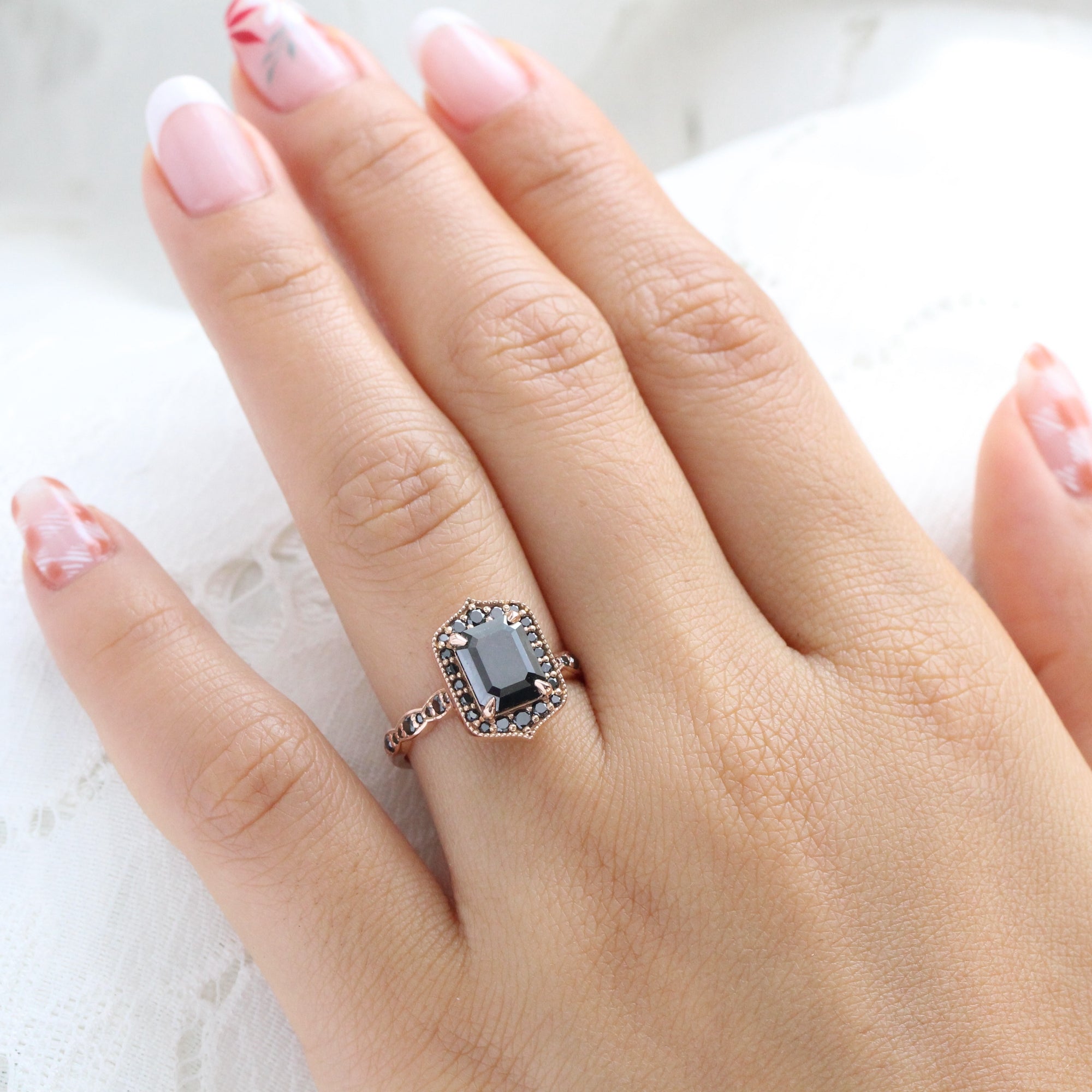 Emerald and black diamond ring top
