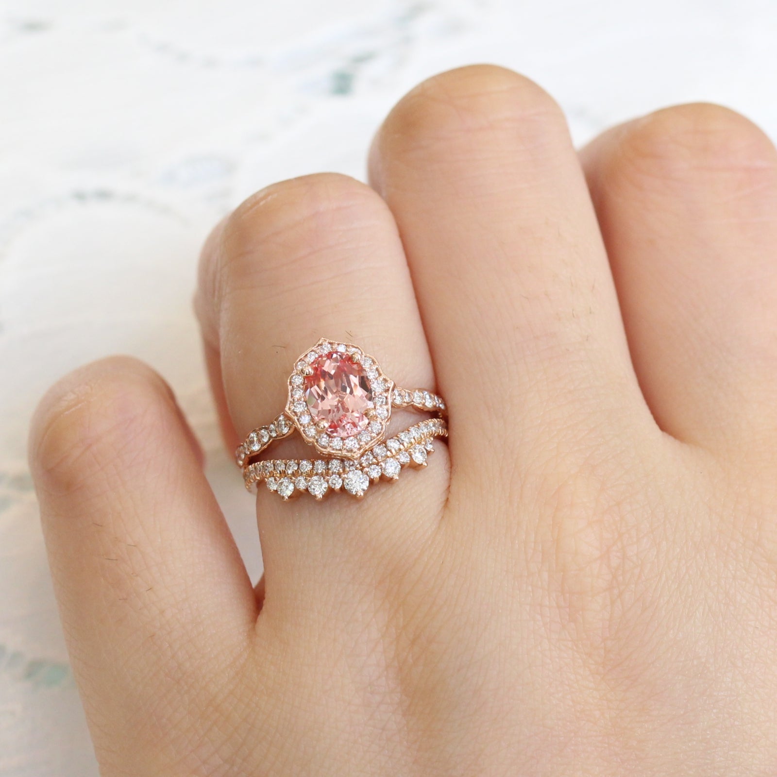 peach sapphire ring and curved crown diamond band in rose gold bridal set by la more design