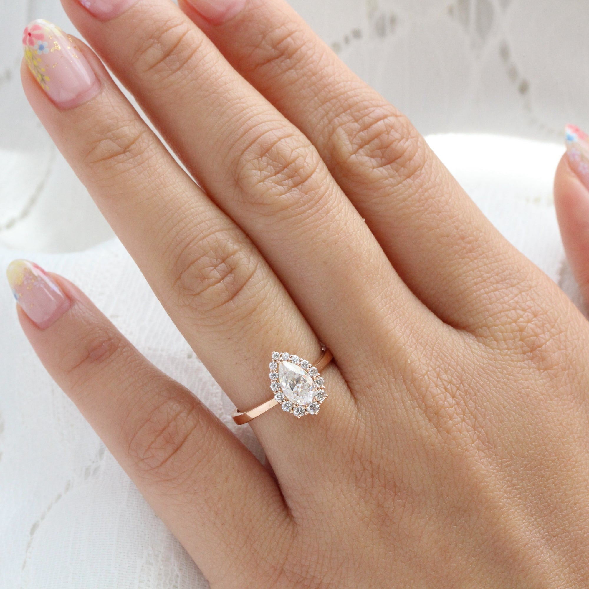 Pear shaped diamond ring on finger Clearance