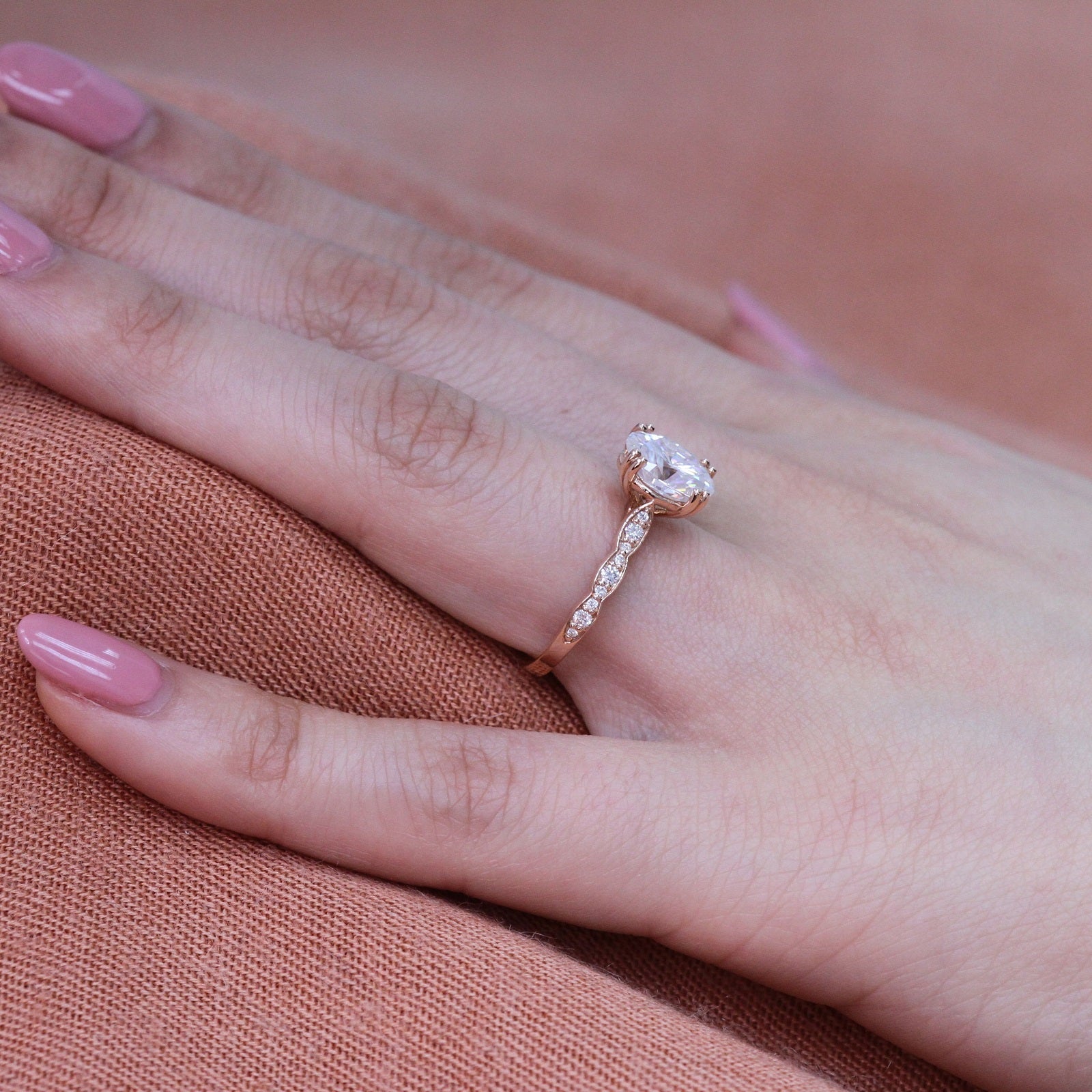 oval moissanite solitaire engagement ring in rose gold scalloped diamond band by la more design