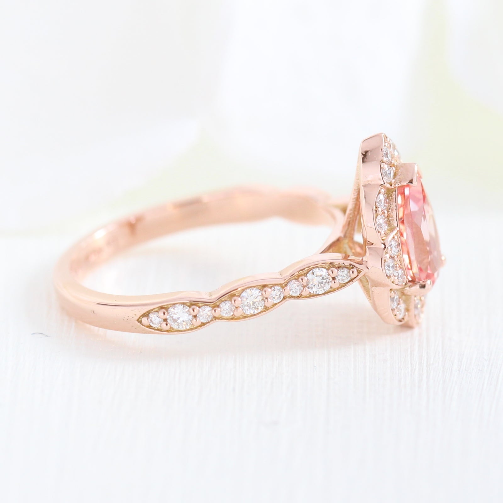 vintage inspired peach sapphire pear engagement ring in rose gold curved diamond band by la more design jewelry