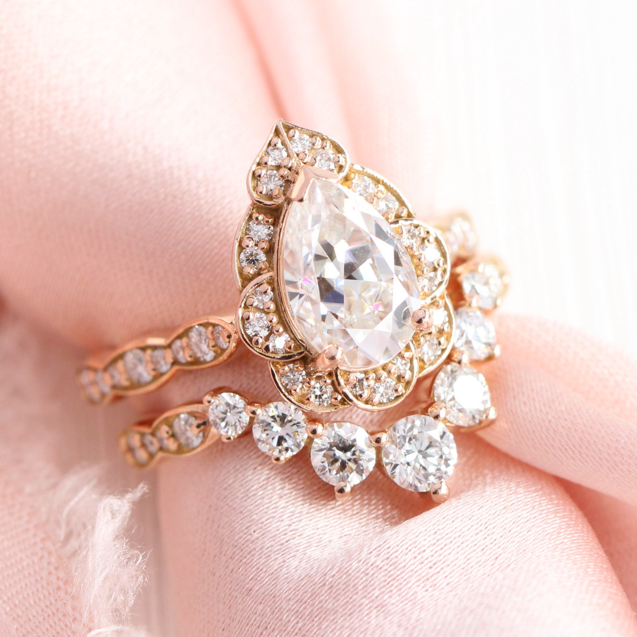 Vintage halo pear moissanite engagement ring stack rose gold bridal set with v-shaped diamond wedding band by la more design jewelry