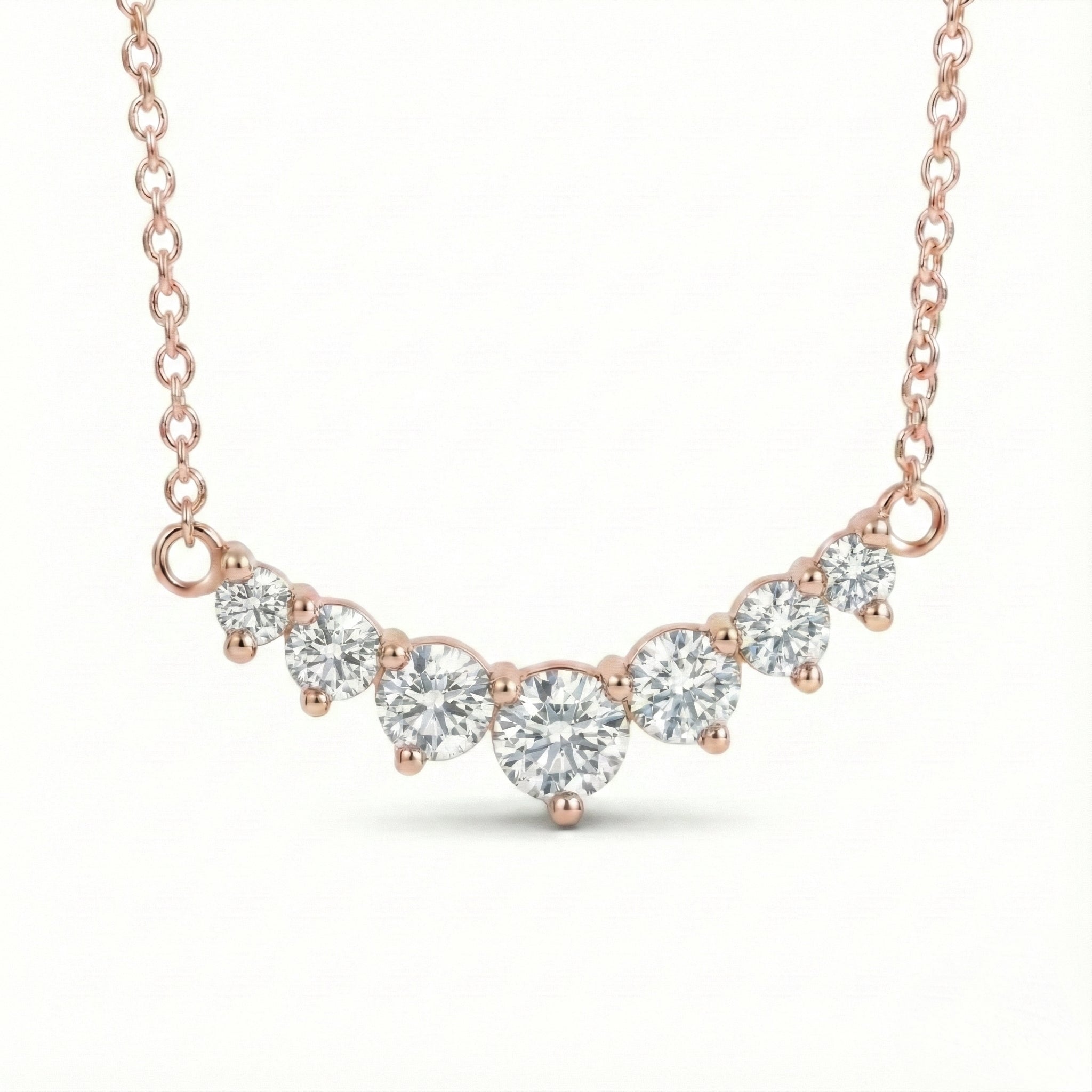 14k rose gold diamond arc necklace with 7 graduated round diamonds in a curved smile setting pendant la more design jewelry