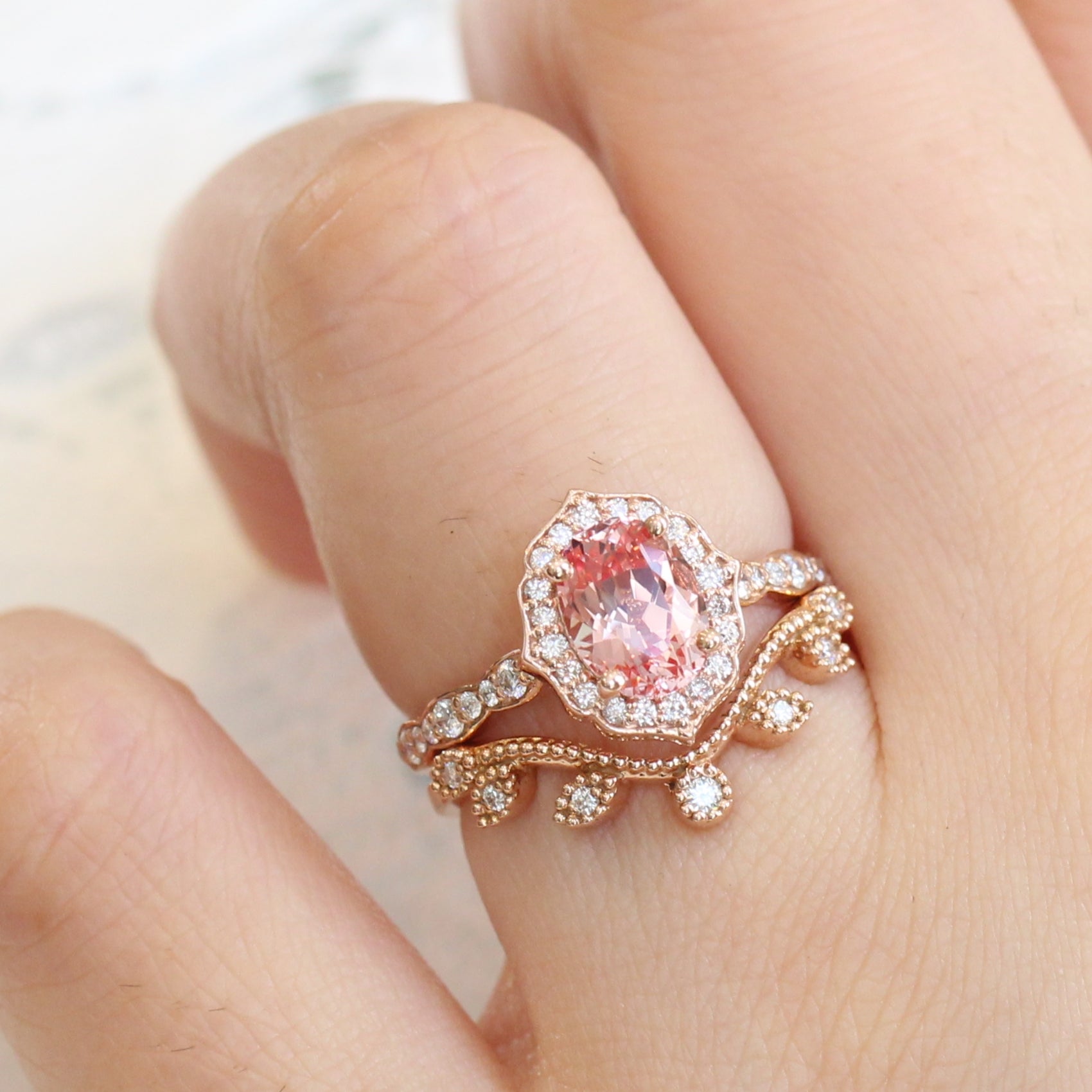 oval peach sapphire ring and curved diamond band in rose gold bridal set by la more design jewelry
