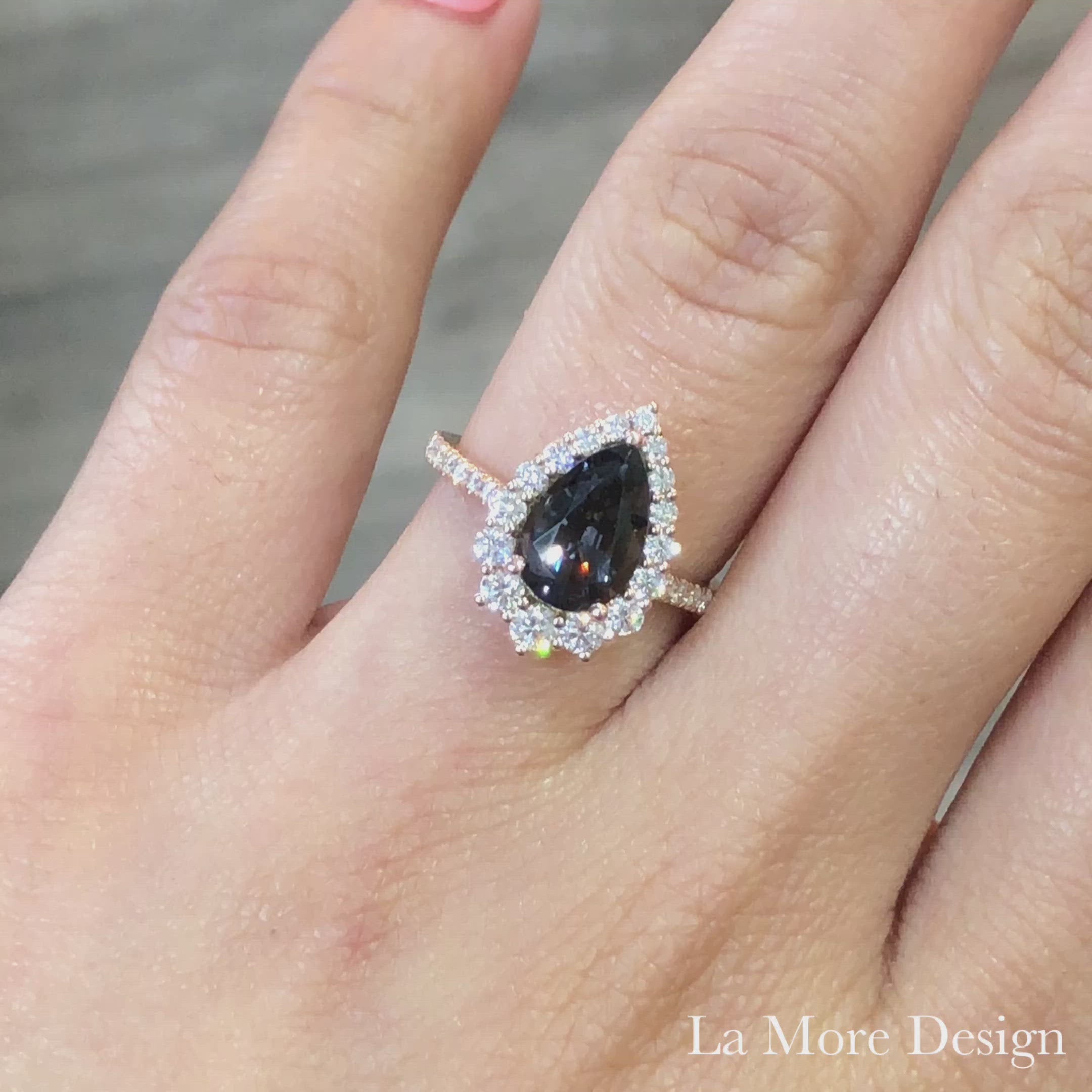 Breathtakingly gorgeous and unique large grey spinel diamond ring is crafted in a 14k rose gold tiara halo diamond ring setting featuring a large 2.05-carat pear cut natural grey spinel center encircled by a halo of brilliant white diamonds to create the truly one of a kind look ~ the total gemstone and diamond weight of the whole ring is 2.75 ct.tw.