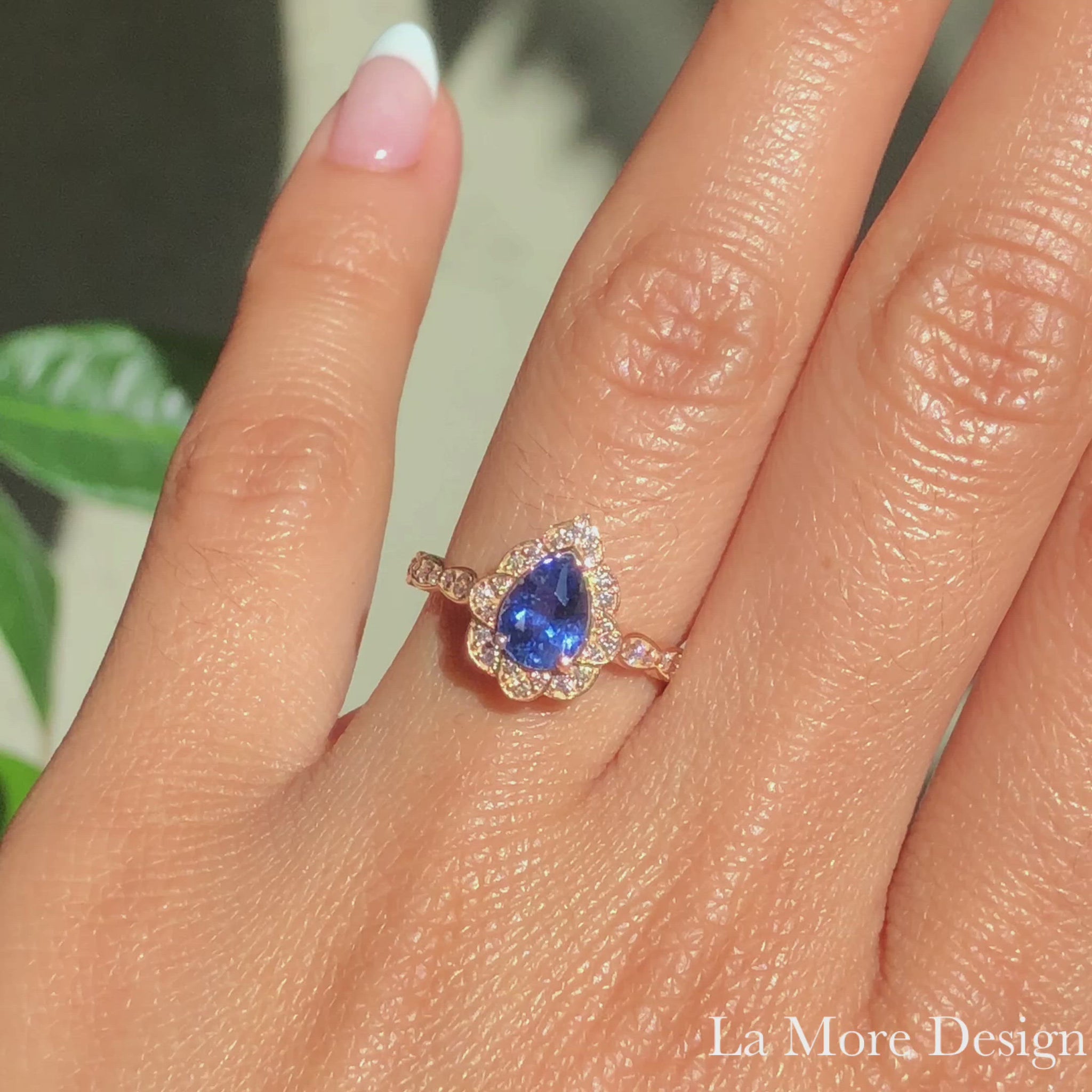 This breathtakingly gorgeous sapphire engagement ring is crafted in 14k rose gold vintage floral diamond ring setting with a 1.25-carat pear cut natural blue sapphire center ~ total gemstone and diamond weight of the whole ring is 1.57 ct.tw.  This unique yet elegant vintage-inspired pear-cut engagement ring will guarantee a big smile on your future bride's face! All our wedding bands can pair beautifully with this gorgeous vintage floral diamond sapphire ring!