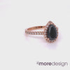 This timelessly elegant yet unique black diamond engagement ring features a 9x6mm natural pear cut black diamond surrounded by sparkling conflict free white diamonds set in 14k rose gold halo diamond ring setting and finished in a half eternity pave diamond band to add extra sparkles to this beautiful halo pear engagement ring. 