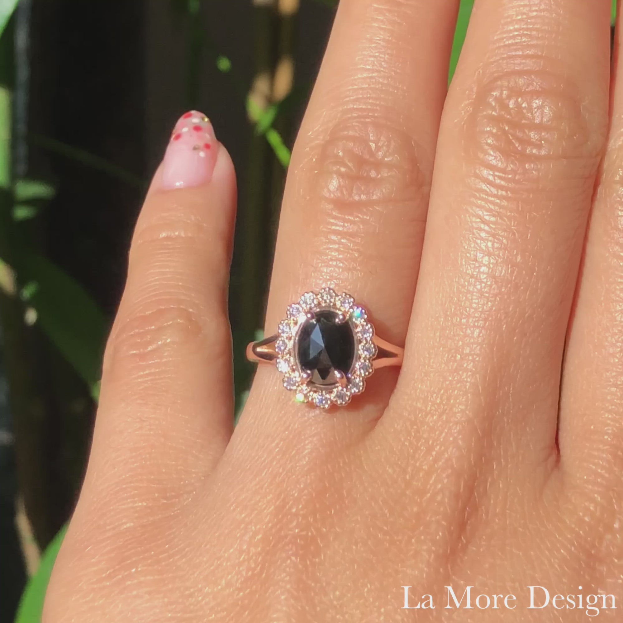 Vintage inspired rose cut black diamond engagement ring in the split shank is crafted in 14k rose gold vintage luna halo ring setting graced with an 8x6mm oval-shaped rose cut black diamond center surrounded by brilliant white diamonds. The distinctive yet elegant look of this rose cut diamond ring will make your engagement unforgettable! It can be made in your choice of platinum or 14k or 18k yellow, rose, or white gold. A matching bridal ring set is available. 