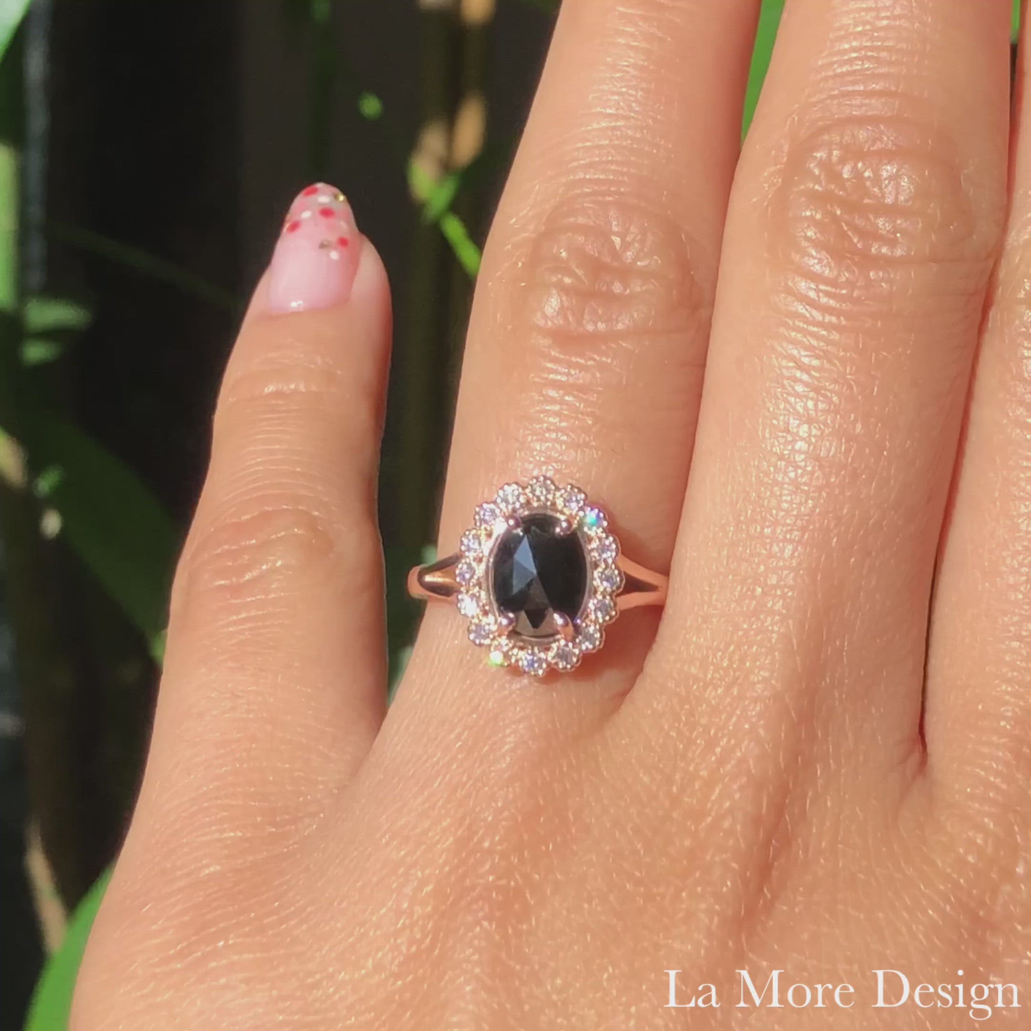 Vintage inspired rose cut black diamond engagement ring in the split shank is crafted in 14k rose gold vintage luna halo ring setting graced with an 8x6mm oval-shaped rose cut black diamond center surrounded by brilliant white diamonds. The distinctive yet elegant look of this rose cut diamond ring will make your engagement unforgettable! It can be made in your choice of platinum or 14k or 18k yellow, rose, or white gold. A matching bridal ring set is available. 