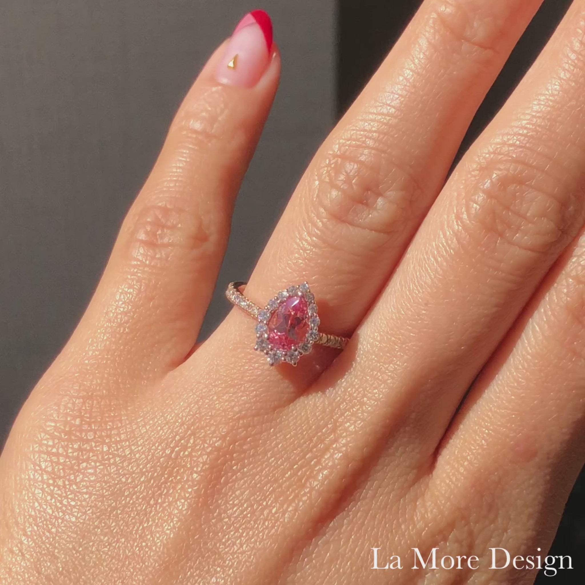 Breathtakingly stunning rose gold halo engagement ring features a 8x5mm pear cut peach sapphire set in our Tiara Halo Diamond ring setting. To add extra sparkles to this already gorgeous ring, brilliant white diamonds are studded to the half eternity band. This halo diamond sapphire engagement ring is perfect for brides looking for a delicate yet unique ring. This pear shaped ring can be made in your choice of platinum or 14k or 18k yellow, rose or white gold. Matching bridal ring set is available.
