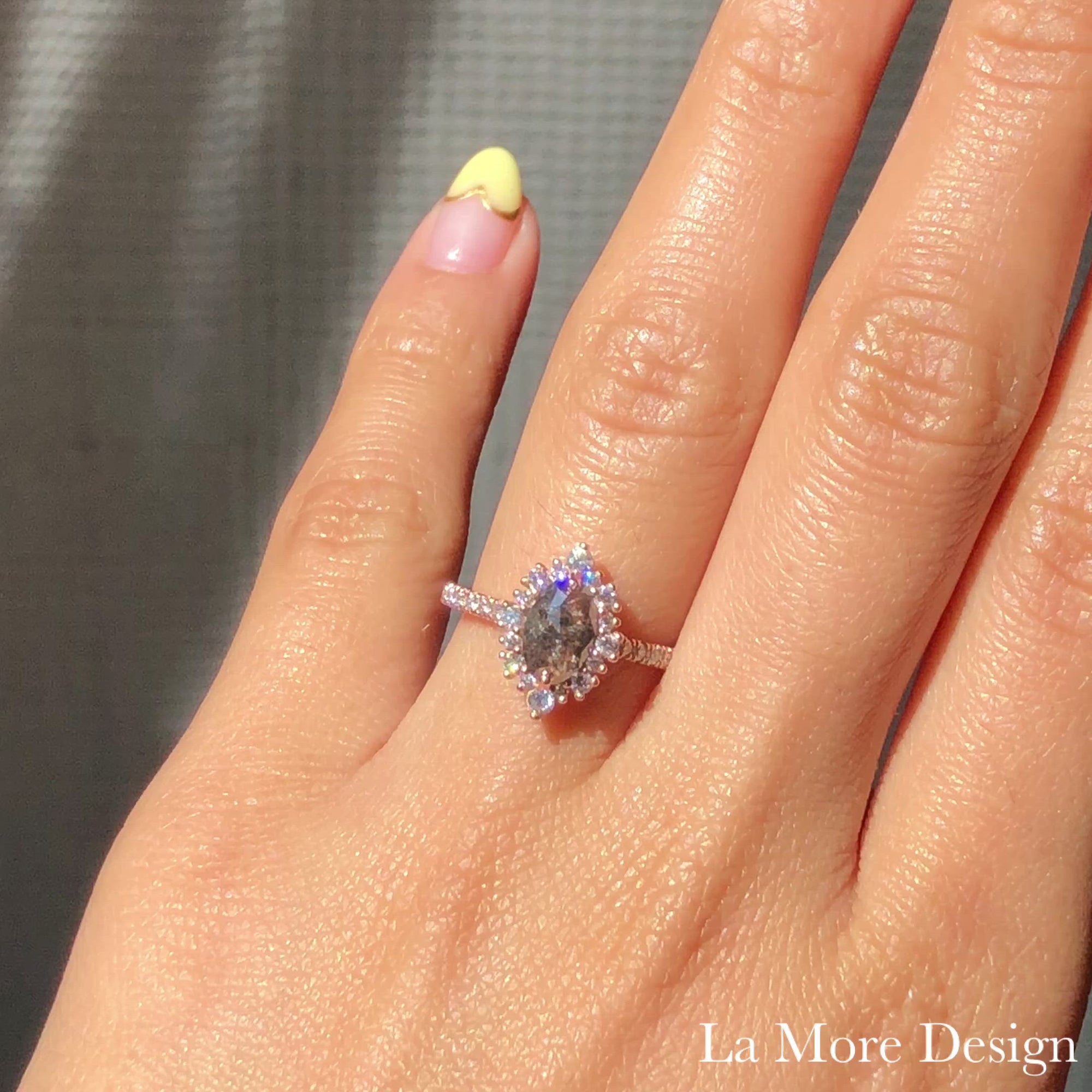 Breathtakingly stunning salt and pepper diamond engagement ring is crafted in the 14k rose gold tiara halo diamond ring setting with a 0.95-carat marquise-shaped rose cut natural grey diamond center ~ the total diamond weight of the whole ring is 1.43 ct.tw.  