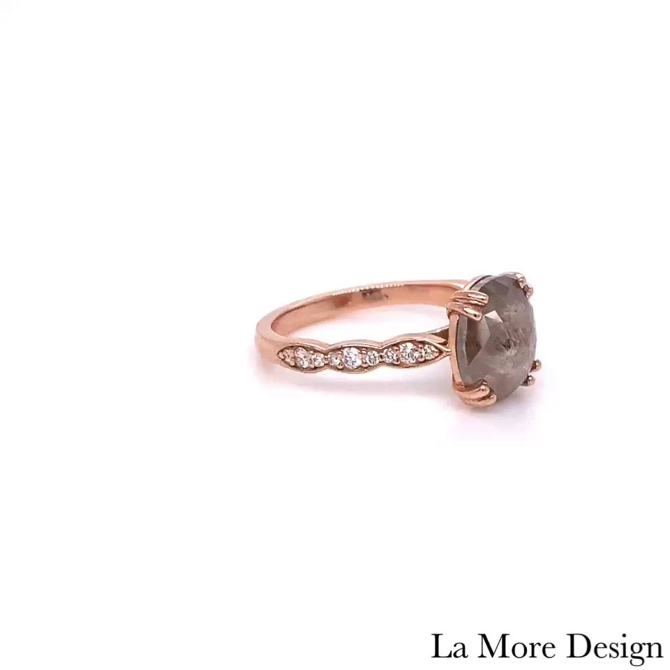 Unique yet timelessly gorgeous salt and pepper diamond engagement ring is crafted in a 14k rose gold Grace solitaire ring setting with a large 2.40-carat oval cut natural light grey diamond center and is finished in our signature scalloped diamond band ~ the total diamond weight of the whole ring is 2.60 ct.tw.  This elegant oval solitaire engagement ring will guarantee a big smile on your future bride's face! All our wedding bands can pair beautifully with this oval-cut grey diamond ring!