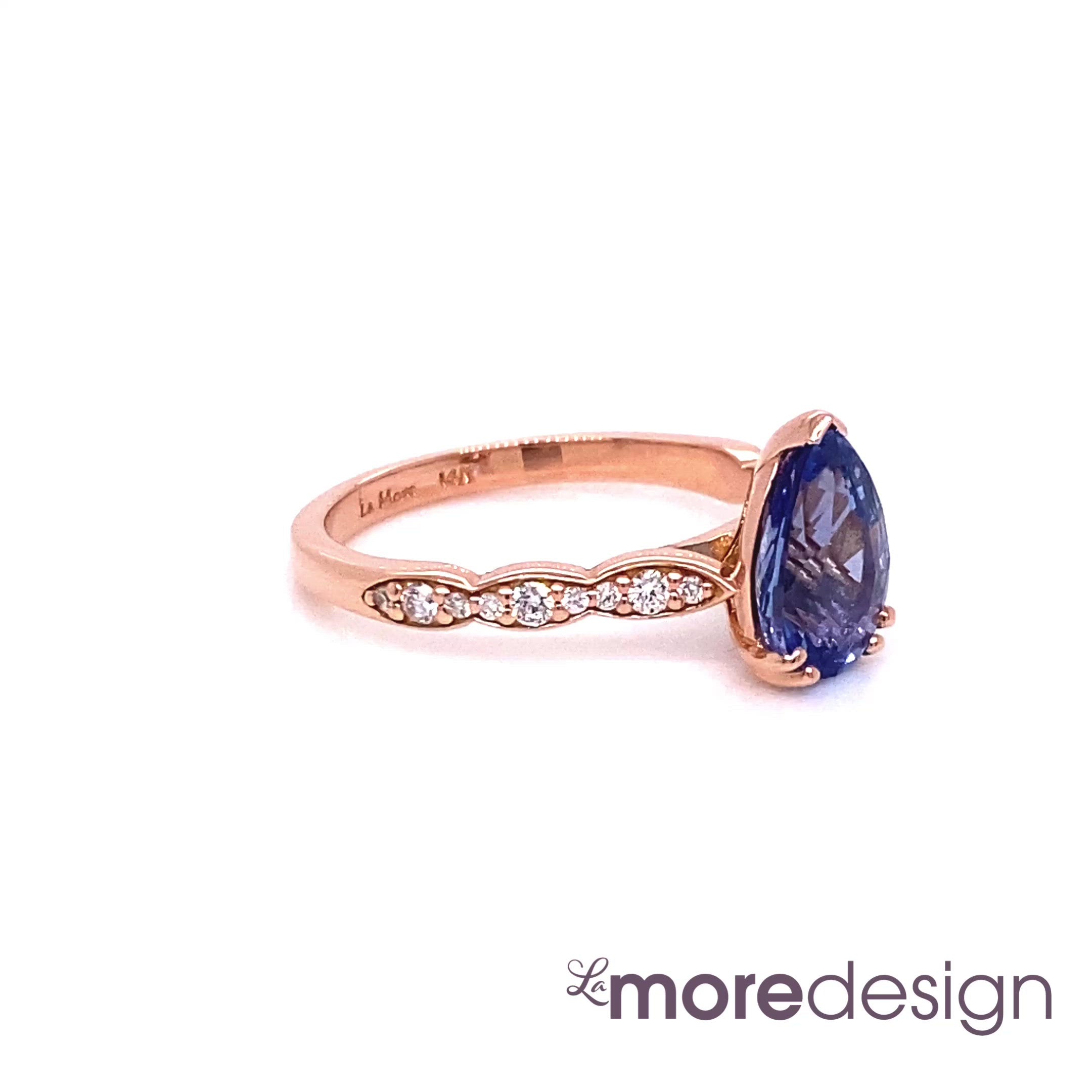 Unique yet timelessly gorgeous sapphire engagement ring is crafted in a 14k rose gold Grace solitaire ring setting with a large 1.98-carat pear cut natural blue sapphire center and is finished in our signature scalloped diamond band ~ the total gemstone and diamond weight of the whole ring is 2.18 ct.tw. This elegant pear solitaire engagement ring will guarantee a big smile on your future bride's face! All our wedding bands can pair beautifully with this pear-cut sapphire diamond ring!