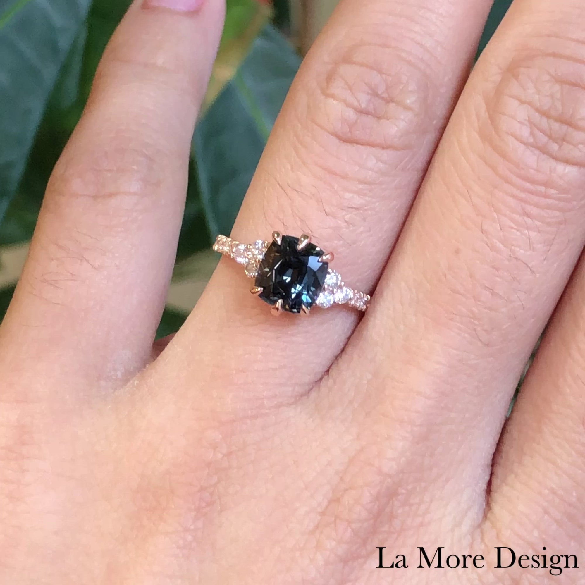 Stunningly unique grey spinel diamond engagement ring crafted in 14k rose gold 3 stone ring setting features a 2.06-carat cushion cut natural grey spinel center and accented by natural white diamonds on each side. To add extra sparkles to this already gorgeous three stone rose gold engagement ring, the ring shank is finished in a pave diamond band to complete the look ~ total gemstone and diamond weight of the whole ring is 2.40 ct.tw.
