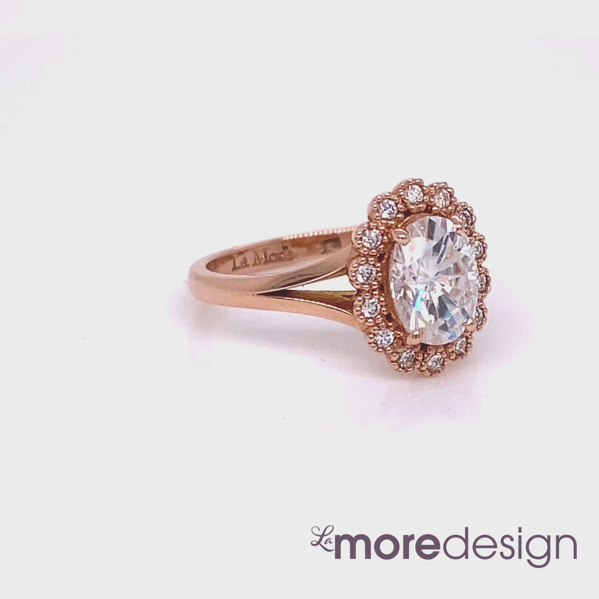 Vintage inspired engagement ring features an oval cut forever one moissnaite set in 14k rose gold milgrain halo diamond ring setting and is finished in split shank. The distinctive yet gorgeous look of this moissanite ring will make your engagement unforgettable! 