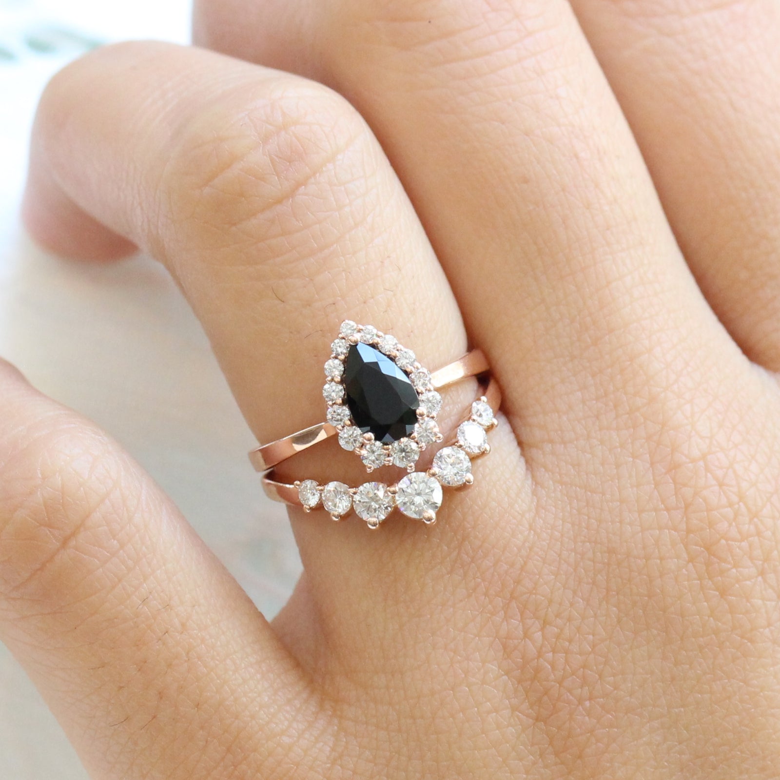 Black spinel diamond pear engagement ring rose gold and curved large diamond wedding band by la more design jewelry