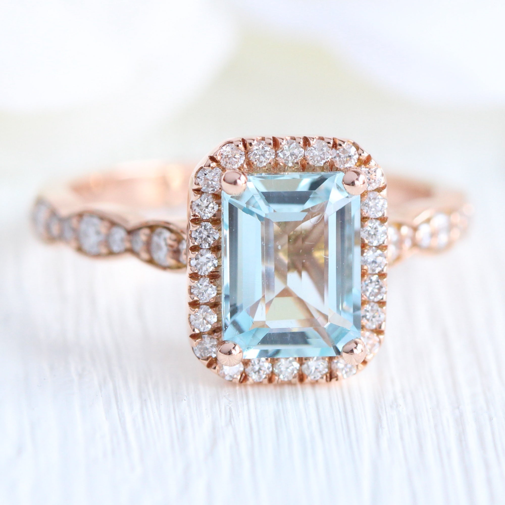 Emerald cut aquamarine engagement ring in rose gold halo diamond ring by la more design