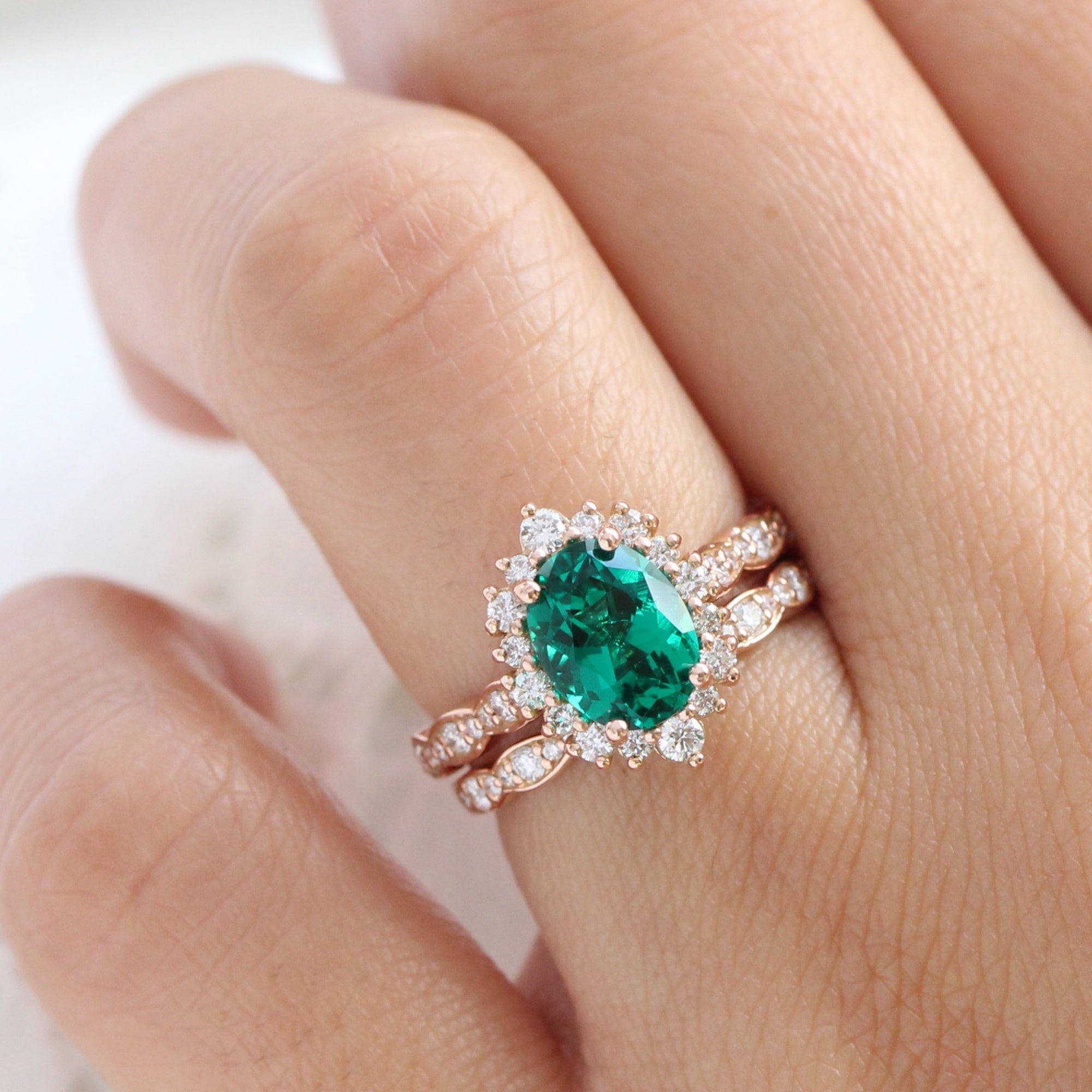 Halo diamond oval emerald ring stock rose gold half eternity wedding band la more design jewelry