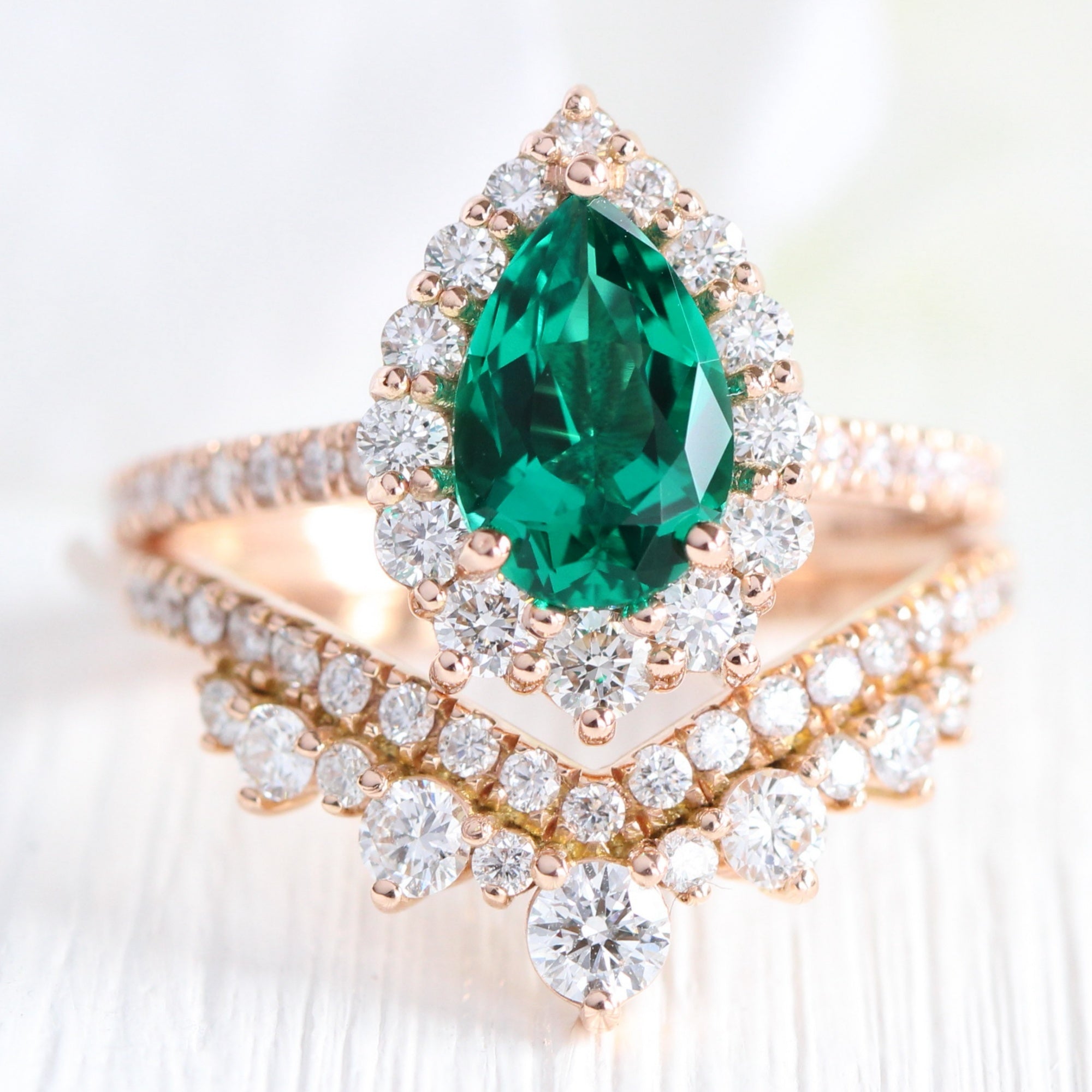 Halo diamond pear emerald ring stock rose gold v shaped wedding band la more design jewelry