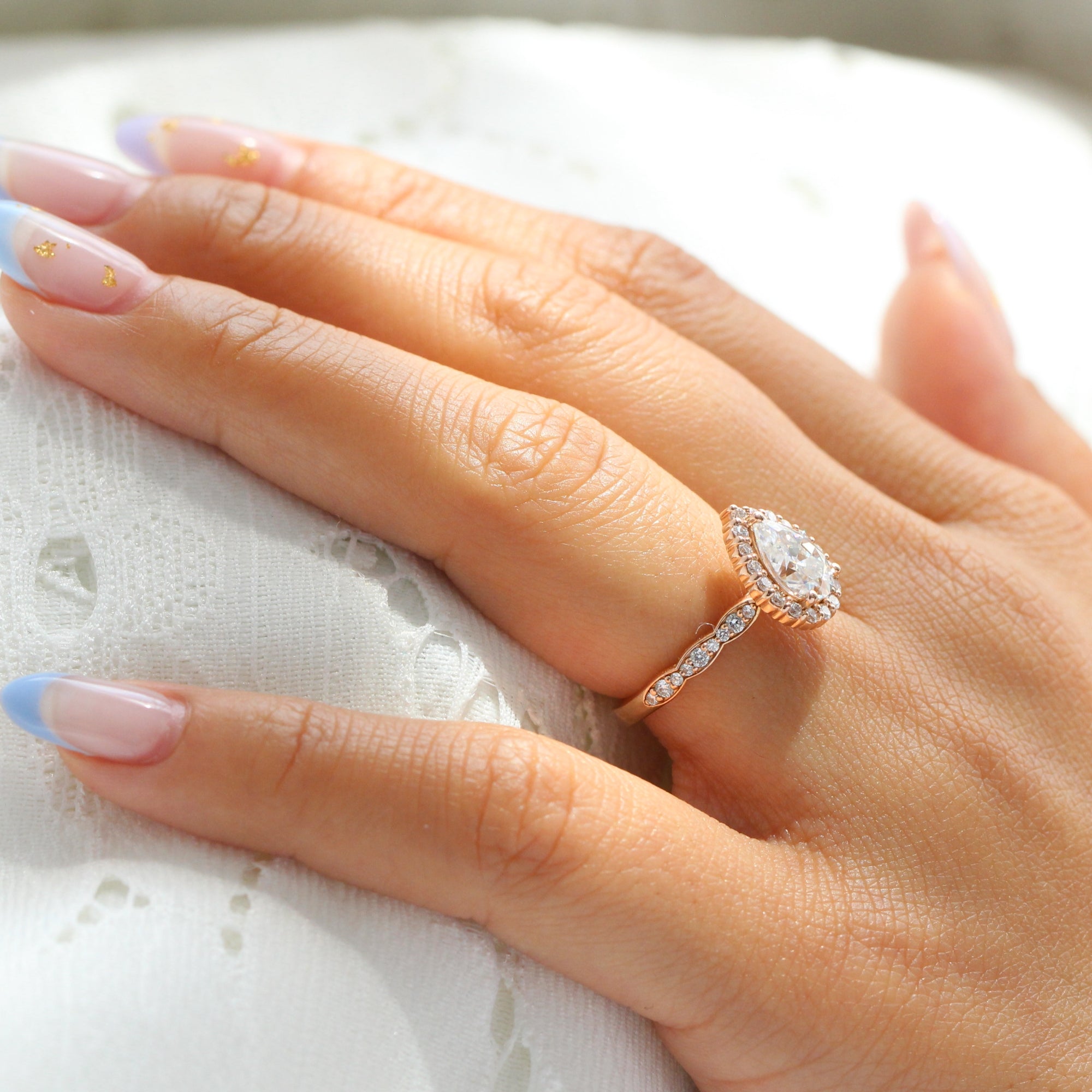 Halo diamond pear moissanite engagement ring in rose gold scalloped band by la more design