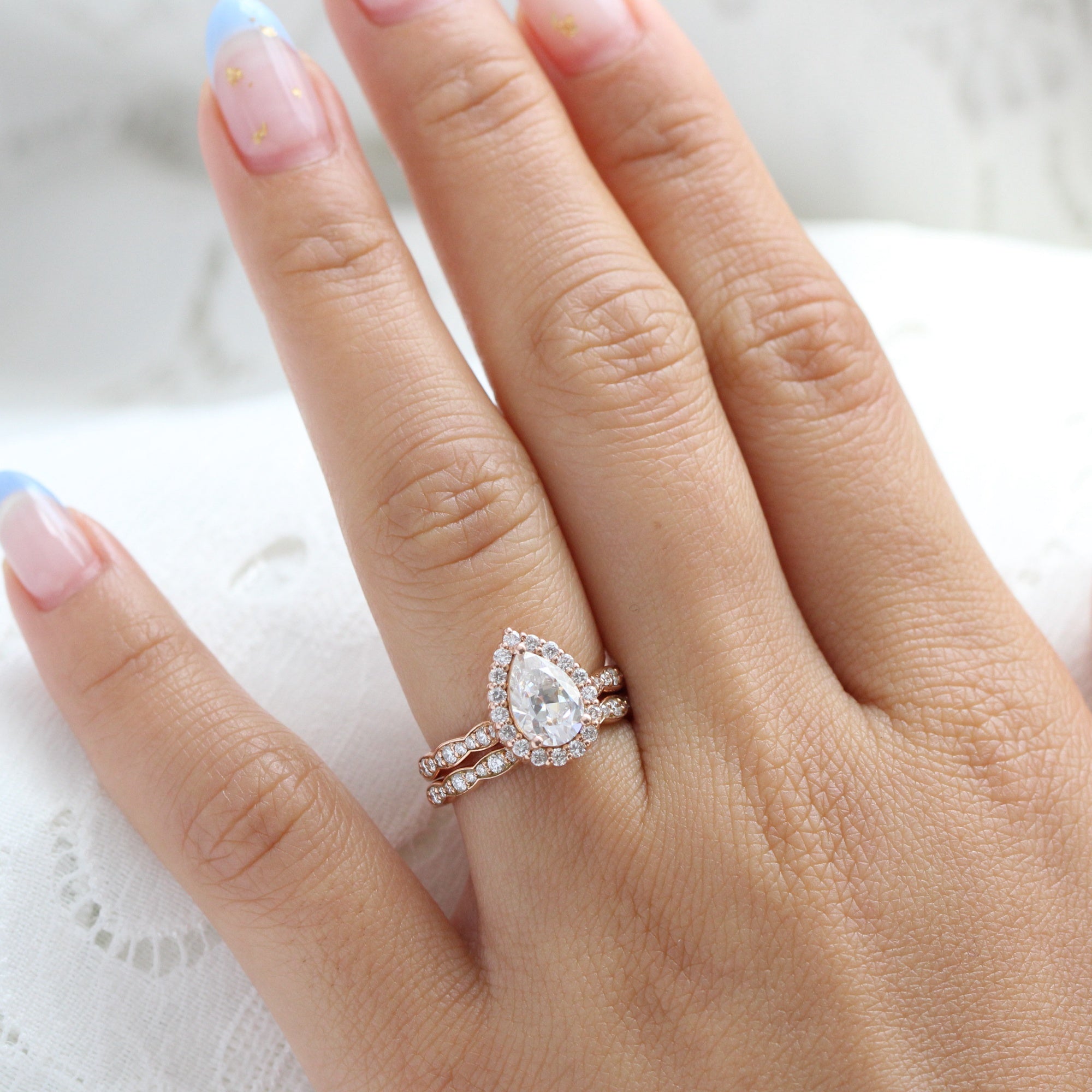 Halo diamond pear moissanite ring bridal set in rose gold scalloped band by la more design jewelry
