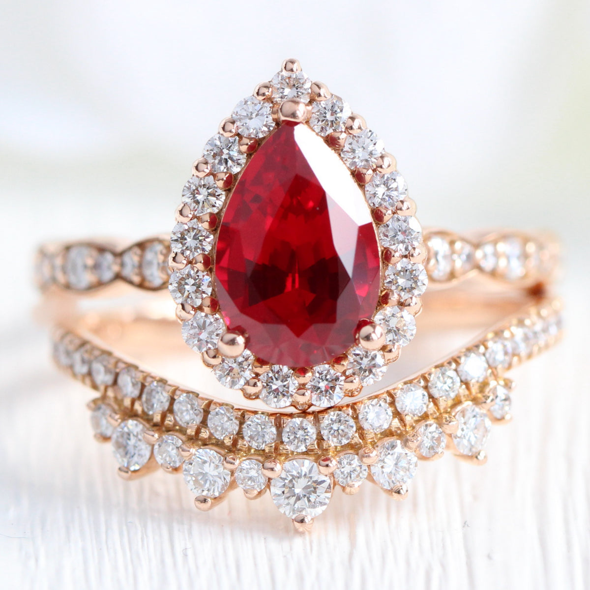 Halo diamond pear ruby ring stack rose gold curved wedding band bridal set la more design jewelry