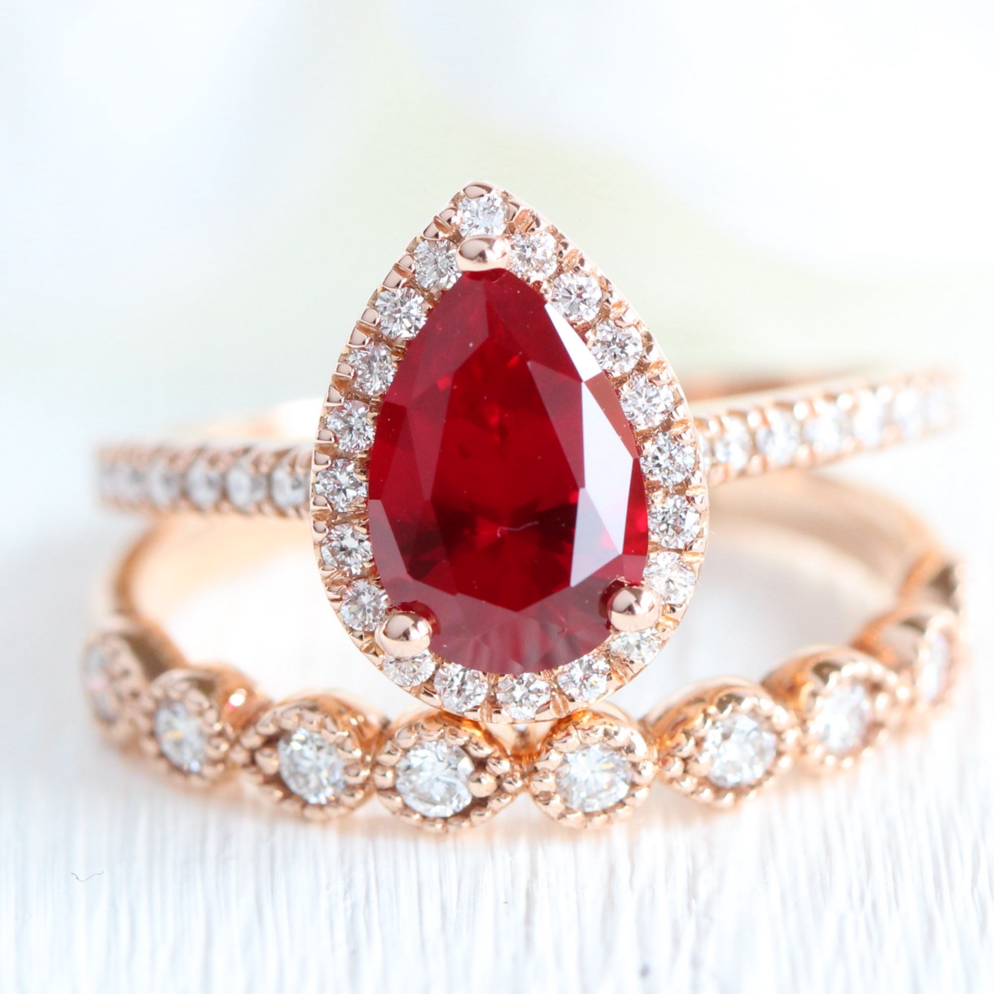 Halo diamond pear ruby ring stack rose gold eternity wedding band la more design jewelry
