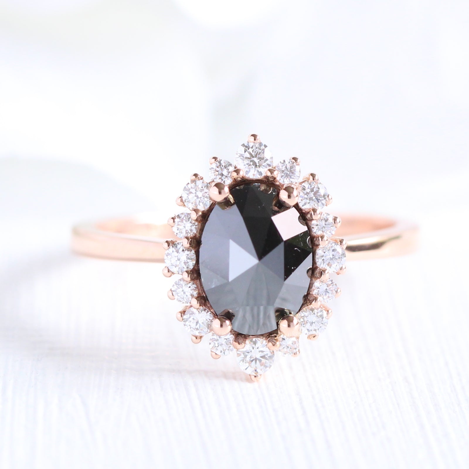 Oval rose cut black diamond engagement ring in rose gold halo diamond band by la more design