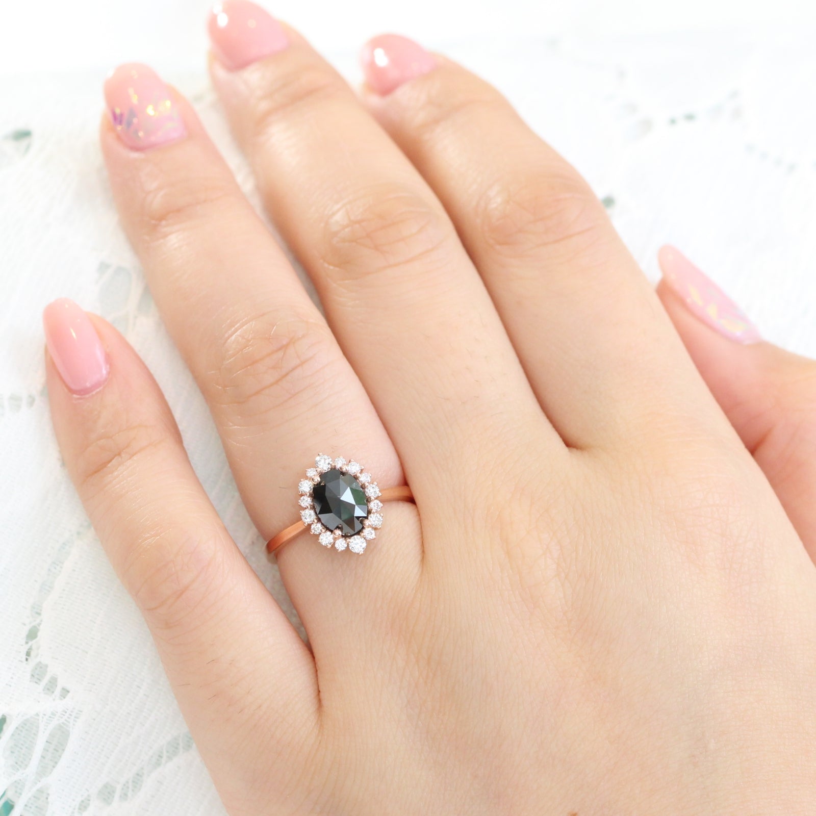Oval rose cut black diamond engagement ring in rose gold halo diamond band by la more design