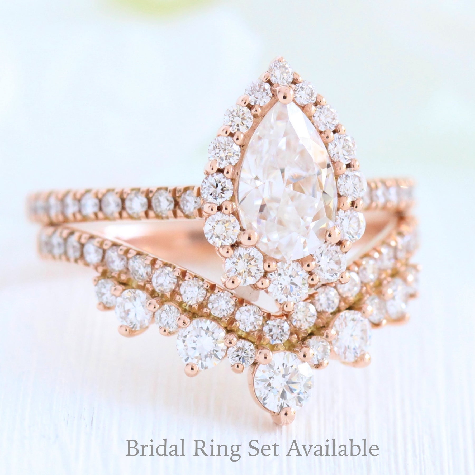 Pear moissanite engagement ring rose gold halo diamond bridal set and contour diamond wedding band by la more design jewelry