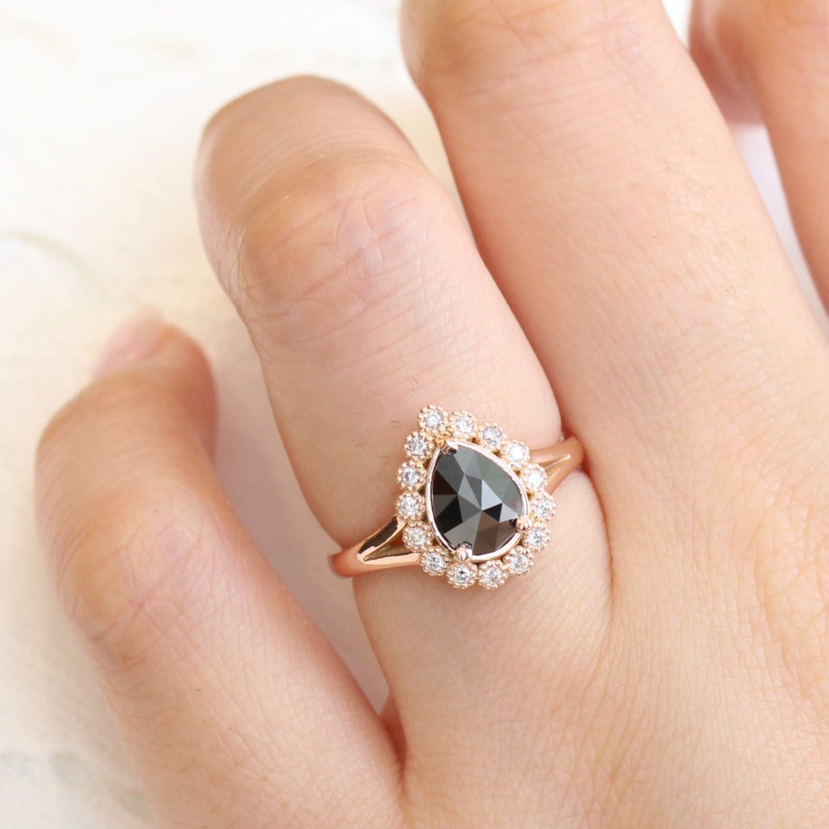Pear rose cut black diamond engagement ring in rose gold halo diamond band by la more design