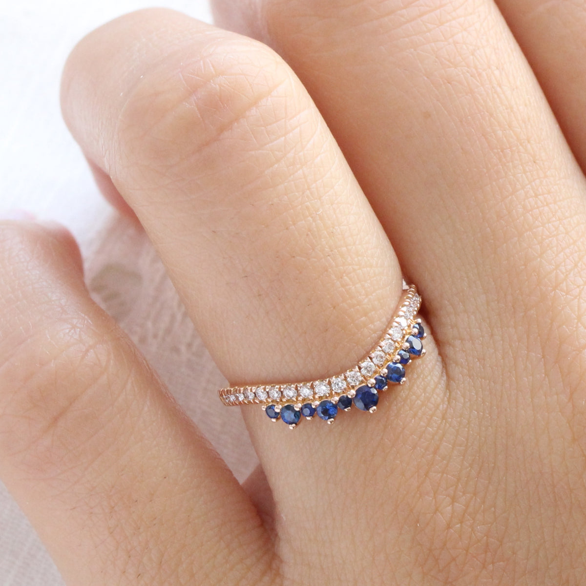 Sapphire and diamond curved wedding ring in rose gold crown band by la more design