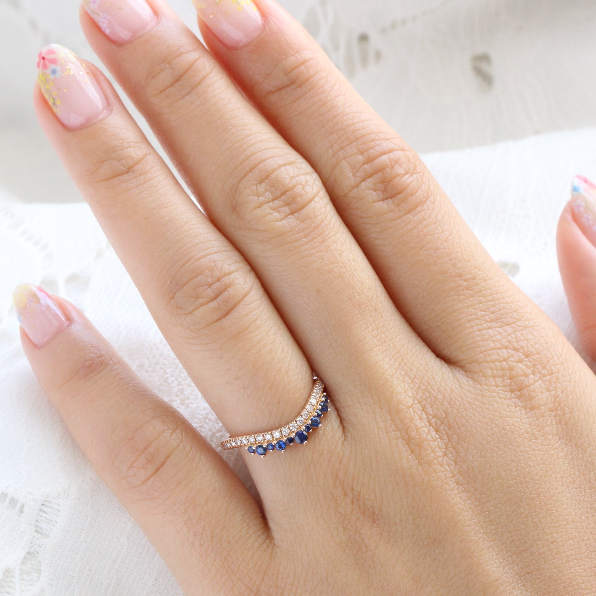 Sapphire and diamond curved wedding ring in rose gold crown band by la more design