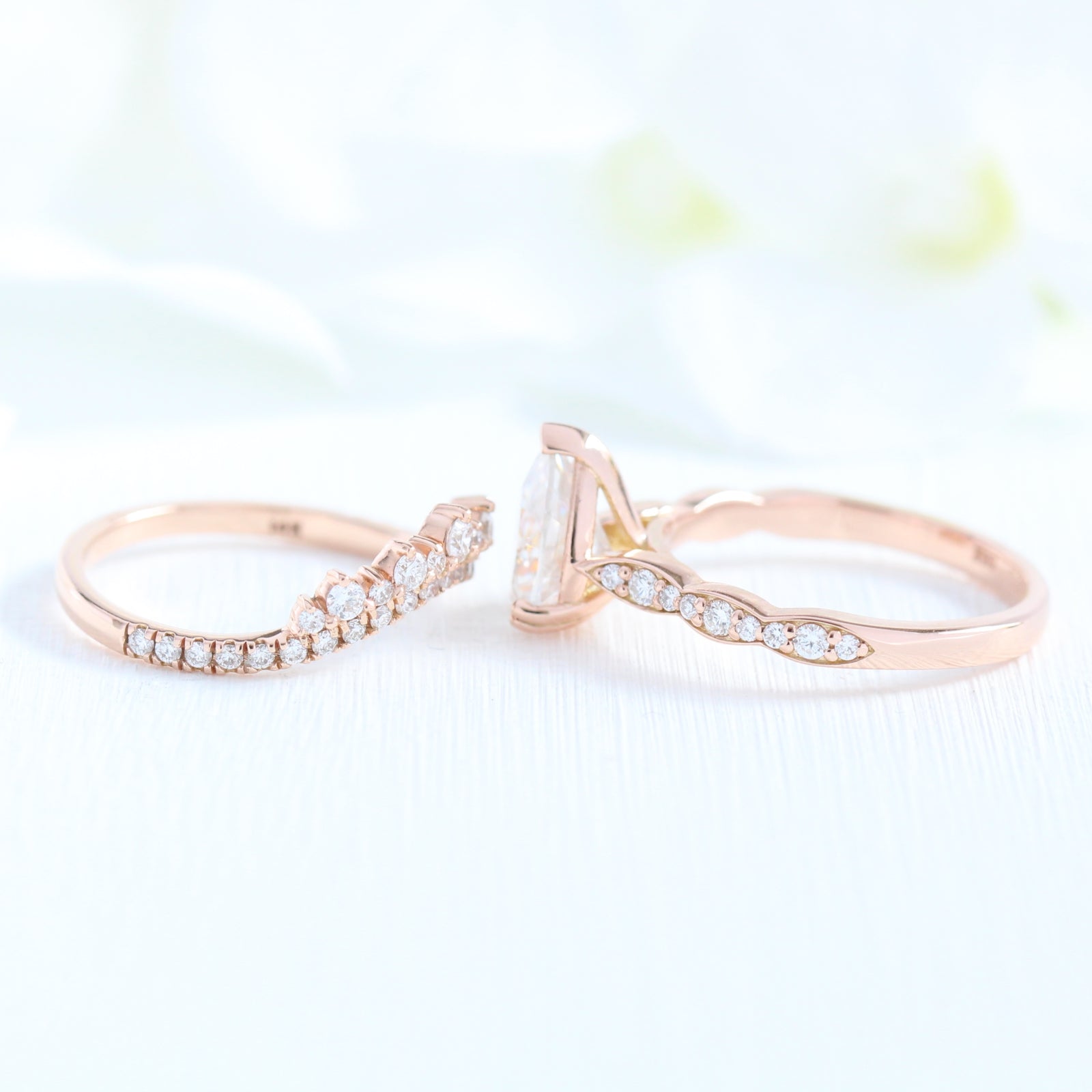 Solitaire pear moissanite ring and curved crown diamond wedding band in rose gold bridal set by la more design jewelry
