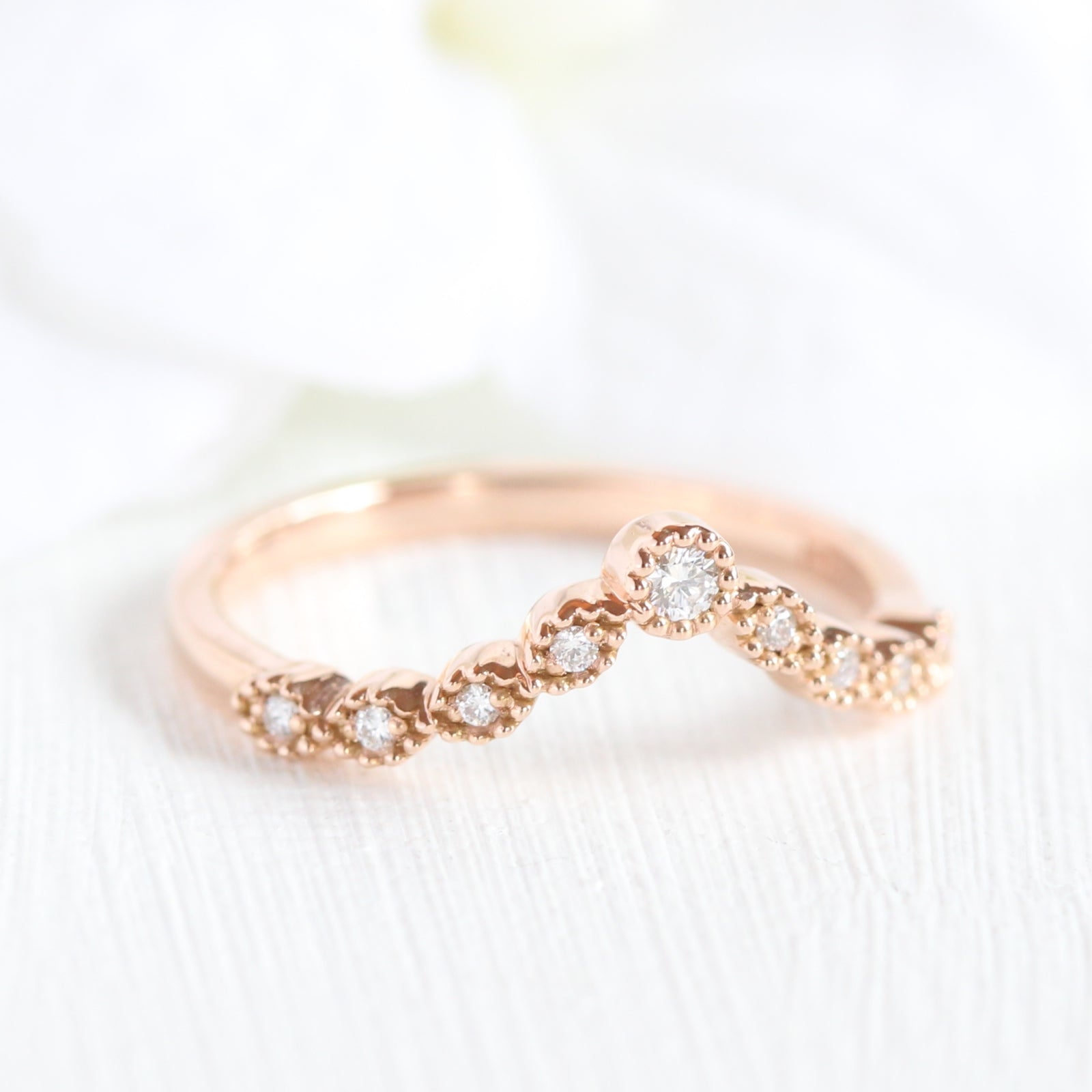 Curved diamond wedding ring in rose gold milgrain band by la more design