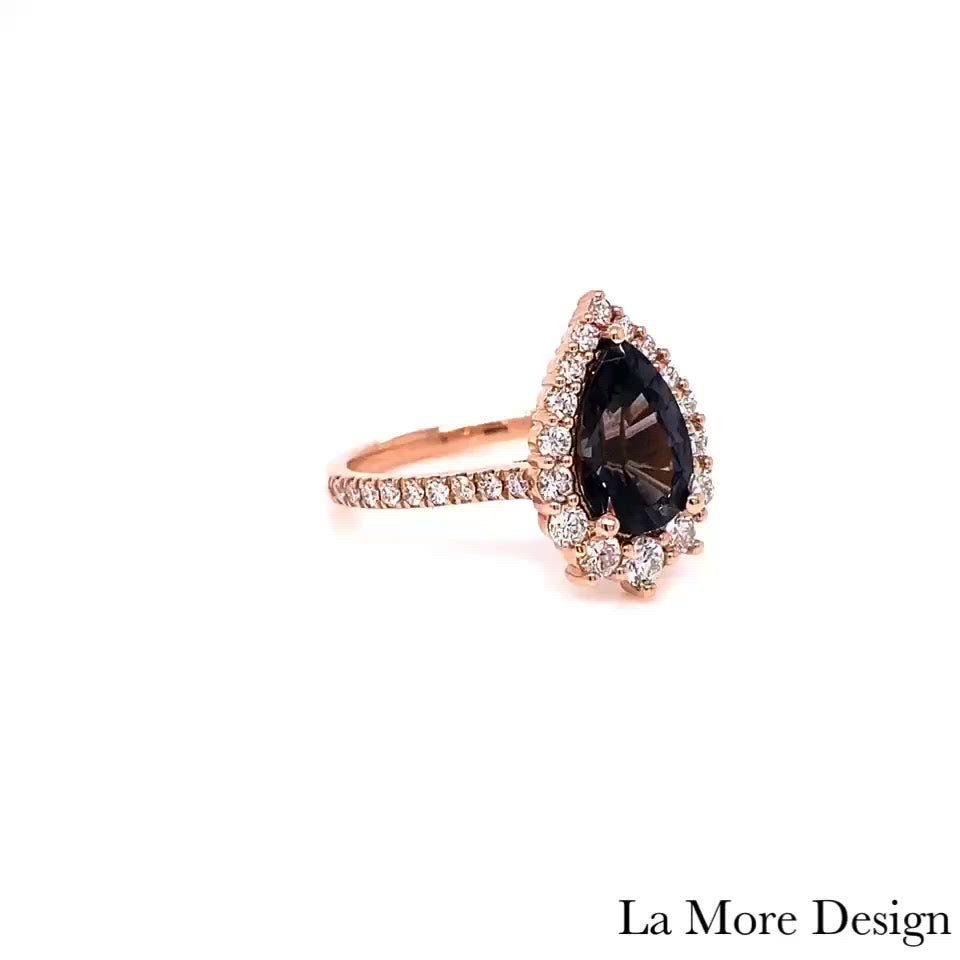 Breathtakingly gorgeous and unique large grey spinel diamond ring is crafted in a 14k rose gold tiara halo diamond ring setting featuring a large 2.05-carat pear cut natural grey spinel center encircled by a halo of brilliant white diamonds to create the truly one of a kind look ~ the total gemstone and diamond weight of the whole ring is 2.75 ct.tw.