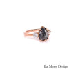 Gorgeous vintage-inspired 3 stone ring with a modern twist! This salt and pepper diamond engagement ring in a 14k rose gold vintage style three stone ring setting features a large 1.60 carats pear cut natural salt and pepper grey diamond center adorned with two brilliant cut white diamonds on each side ~  the total diamond weight of the whole ring is 1.94 carats.  