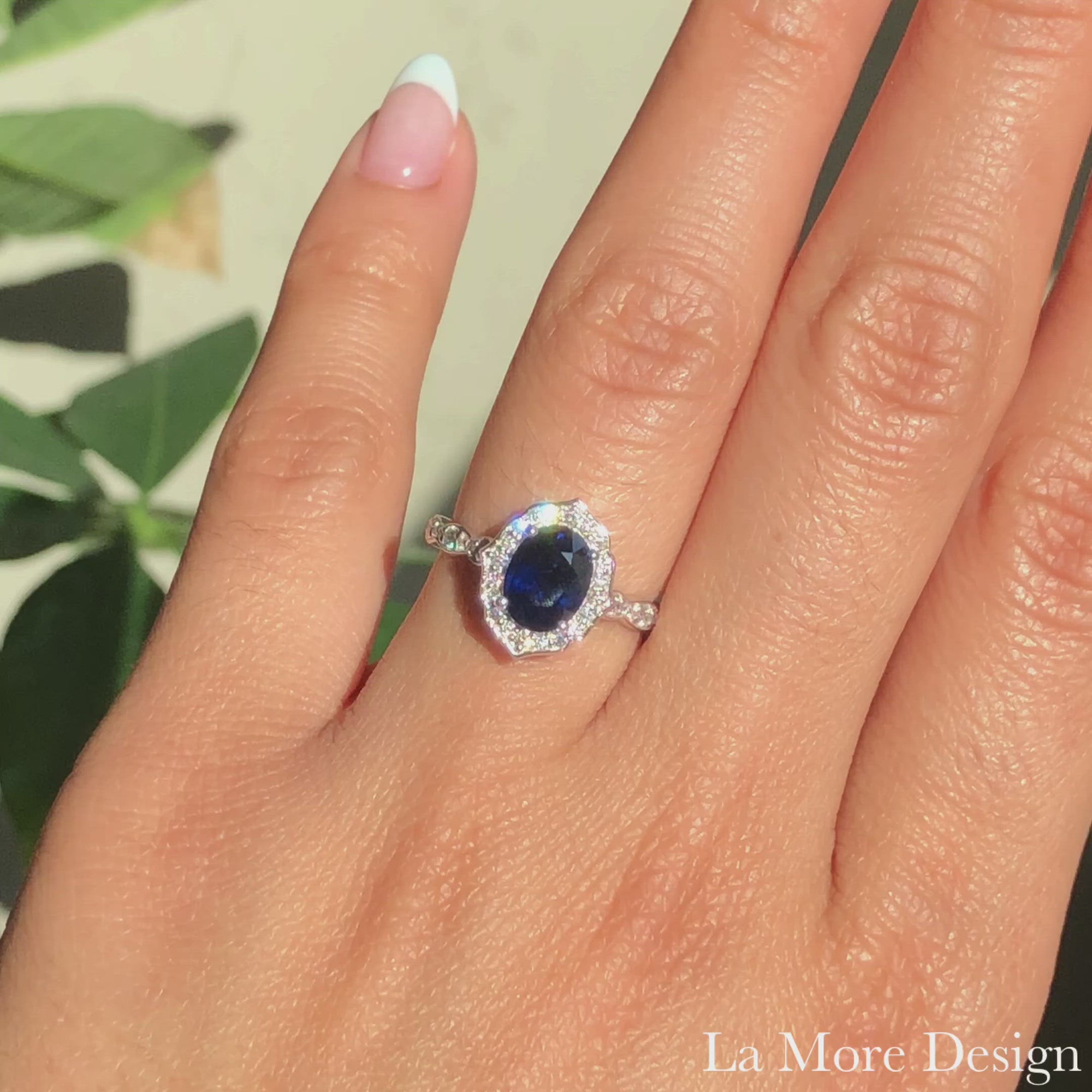 Vintage inspired sapphire engagement ring in 14k white gold floral and scalloped diamond band setting features an 8x6mm oval cut natural blue sapphire for a distinctive and elegant look. Adore your future bride with this unique sapphire ring.