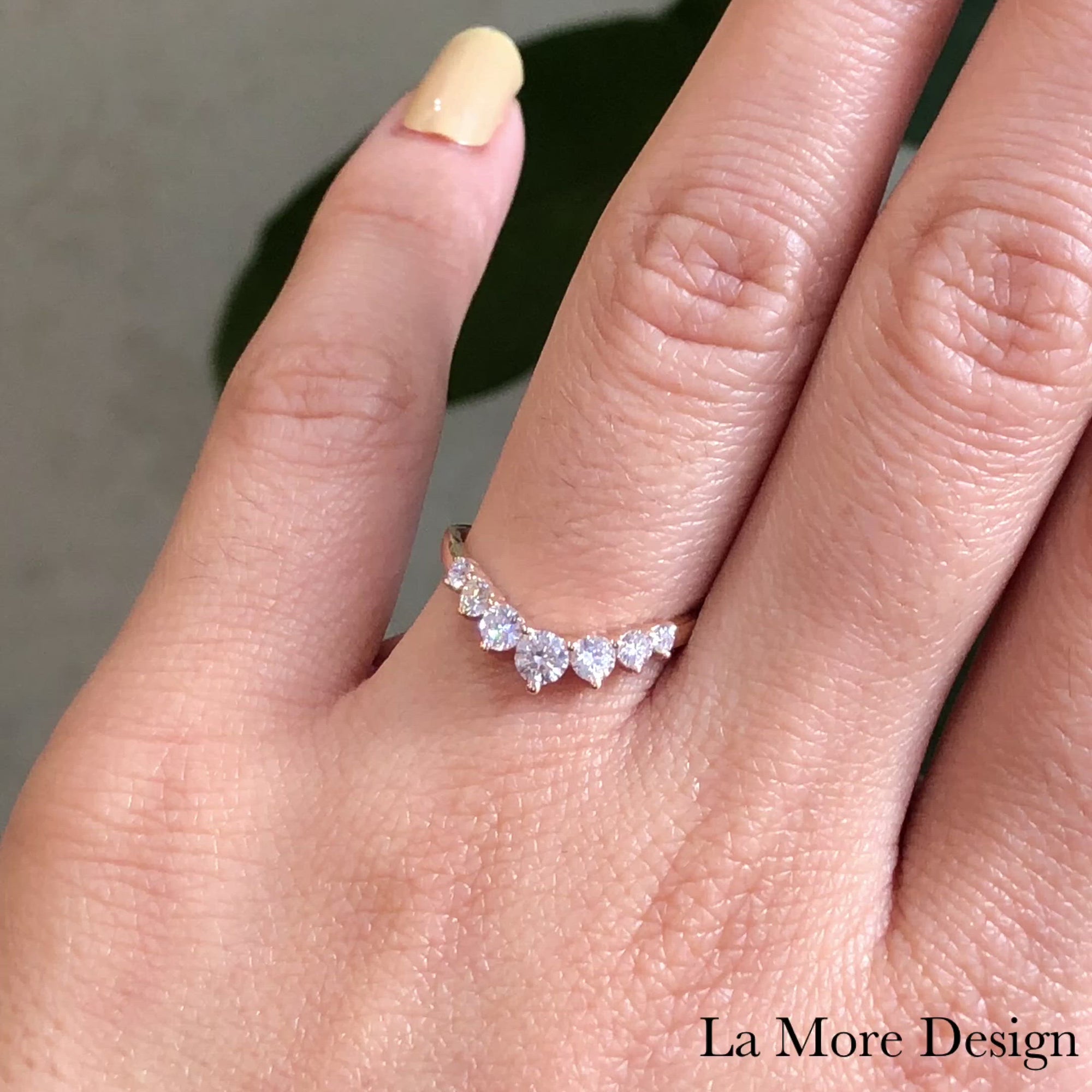 This luminous large diamond ring sparkles from every angle! The curved wedding band showcases seven round brilliant cut diamonds set beautifully in 14k rose gold. This timelessly elegant design of 7 stone diamond wedding ring is finished in a curved band for a breathtakingly stunning effect! This large 7 stone diamond wedding band can nest perfectly with most of our engagement rings as a bridal set or trio wedding set. 