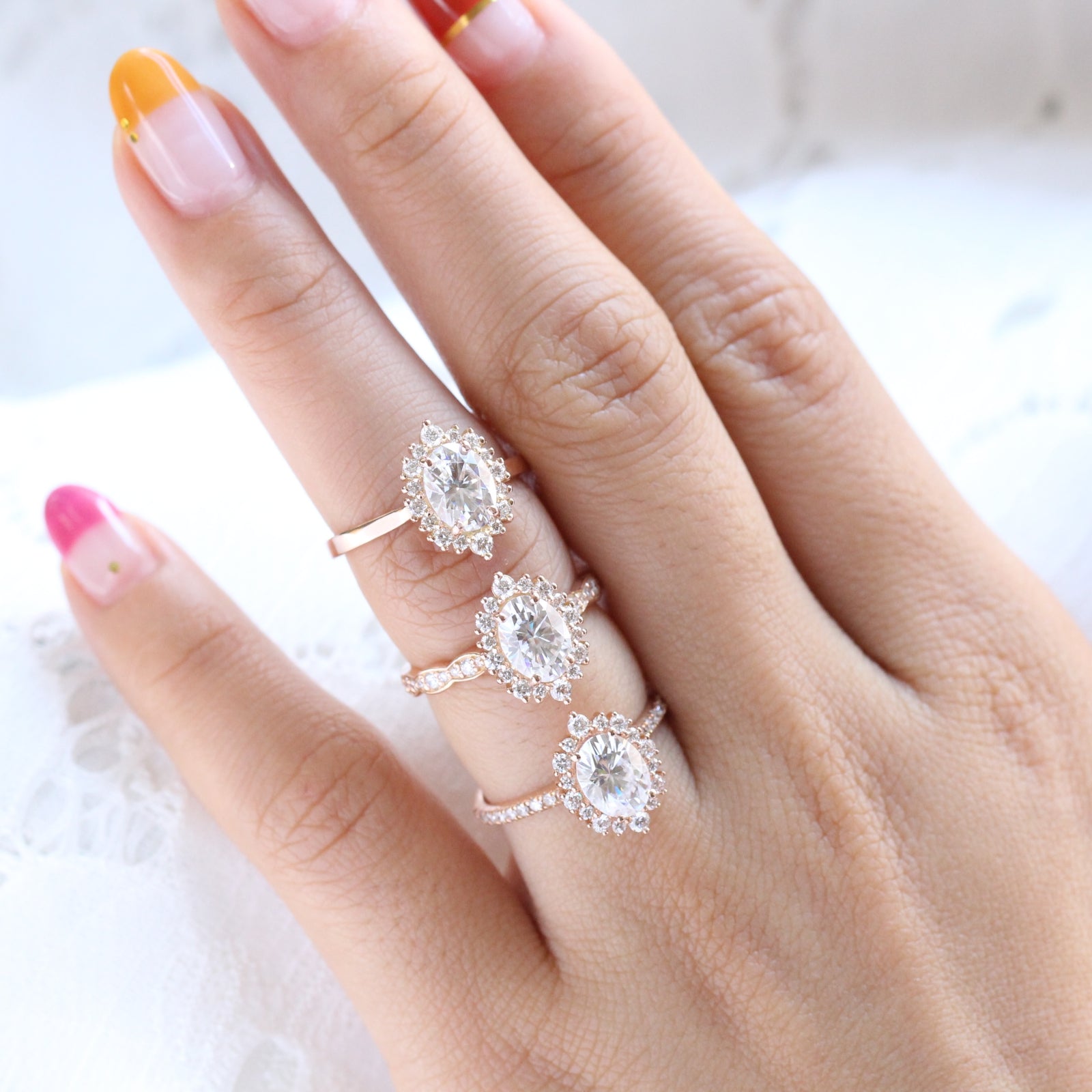 comparison of oval moissanite diamond ring rose gold in plain, scalloped, pave diamond band by la more design jewelry