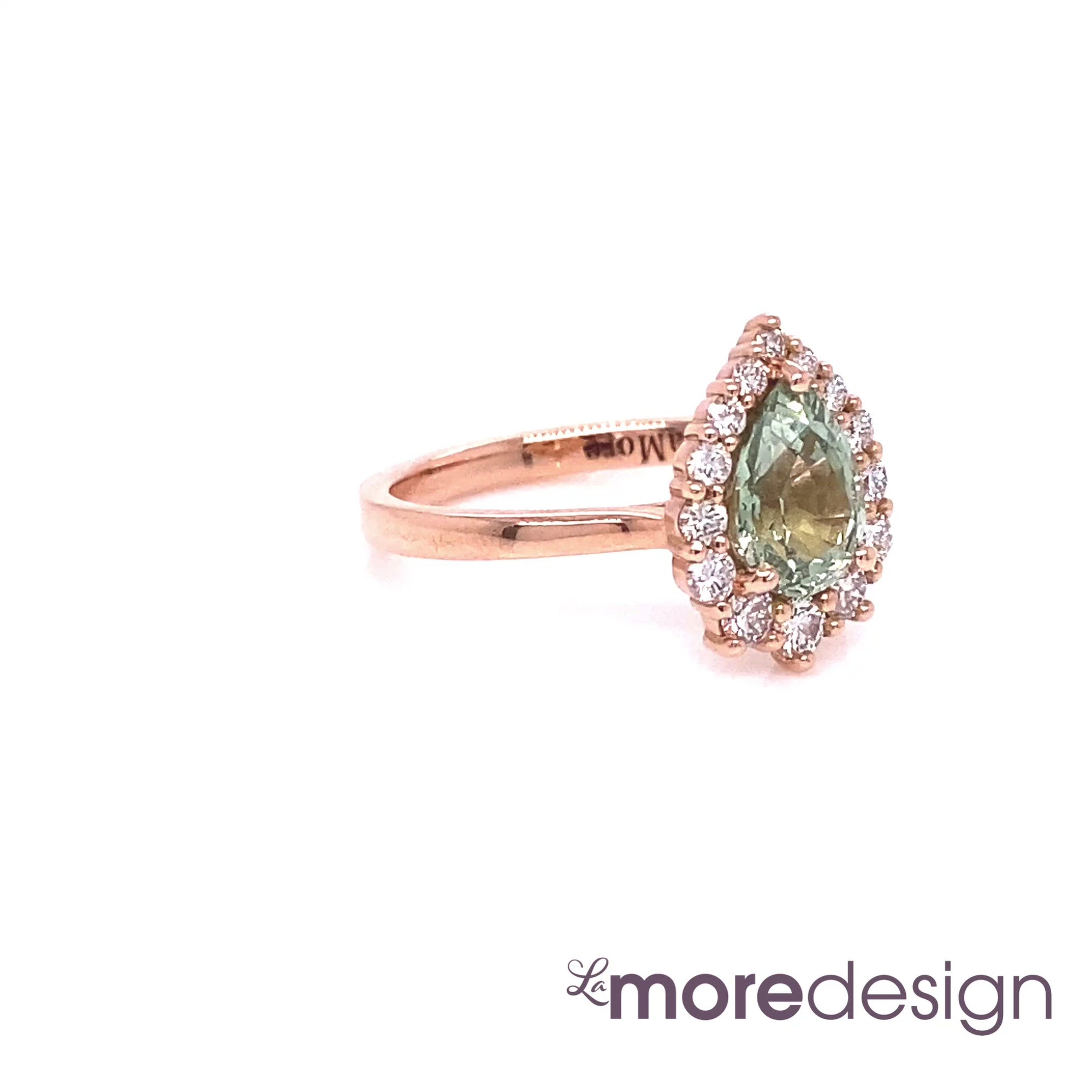 This simply stunning and elegant green sapphire engagement ring is crafted in 14k rose gold Tiara Halo Diamond ring setting with a 1.46-carat pear cut natural sapphire center ~ total gemstone and diamond weight of the whole ring is 1.82 ct.tw.  This one-of-a-kind sapphire diamond ring is perfect for brides looking for diamond alternative engagement rings! All our wedding bands can pair beautifully with this gorgeous halo diamond sapphire ring!