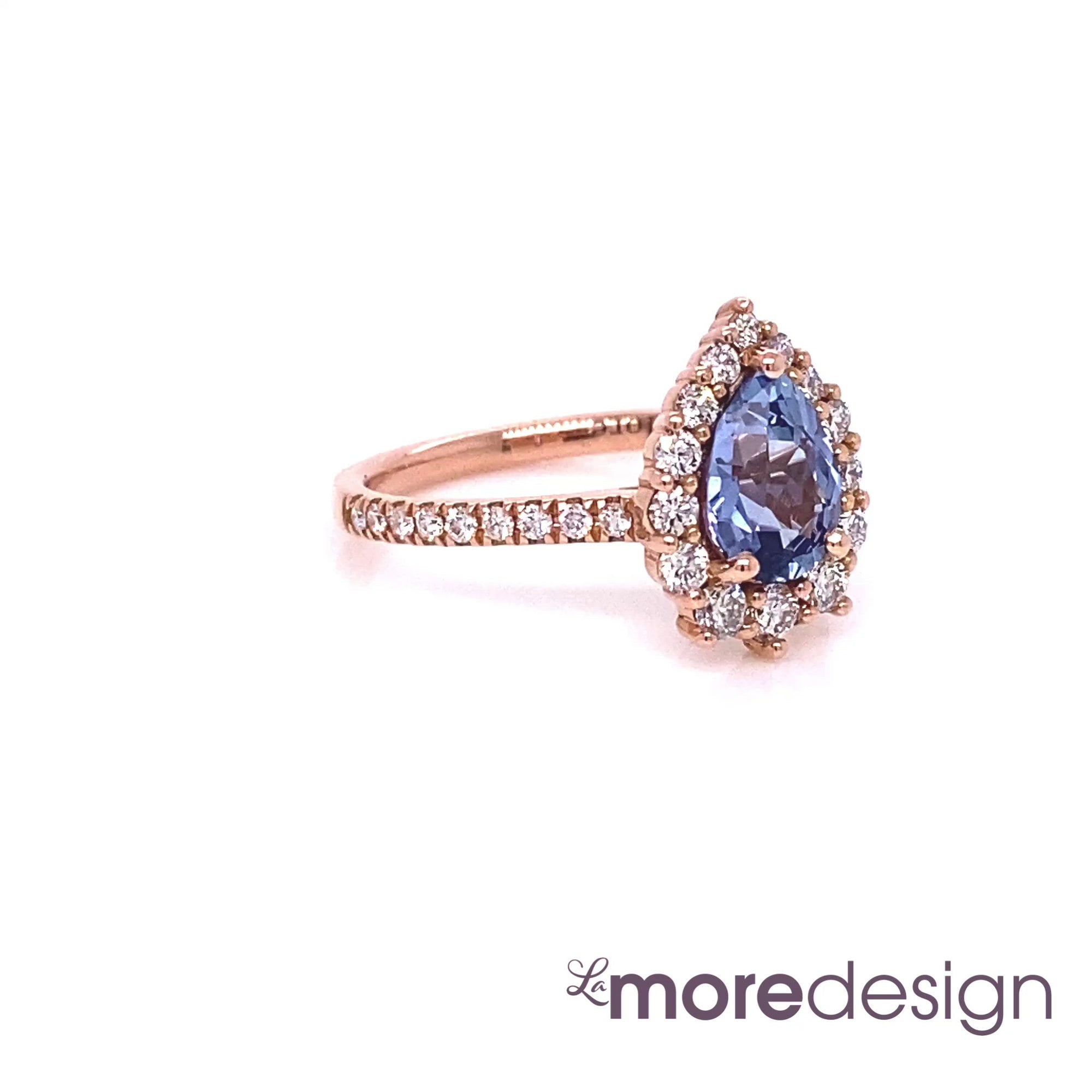 This timelessly elegant blue sapphire engagement ring is crafted in 14k rose gold Tiara Halo Diamond ring setting with a 1.26-carat pear cut natural sapphire center ~ total gemstone and diamond weight of the whole ring is 1.84 ct.tw.  This one-of-a-kind sapphire diamond ring is perfect for brides looking for diamond alternative engagement rings! All our wedding bands can pair beautifully with this gorgeous halo diamond sapphire ring!