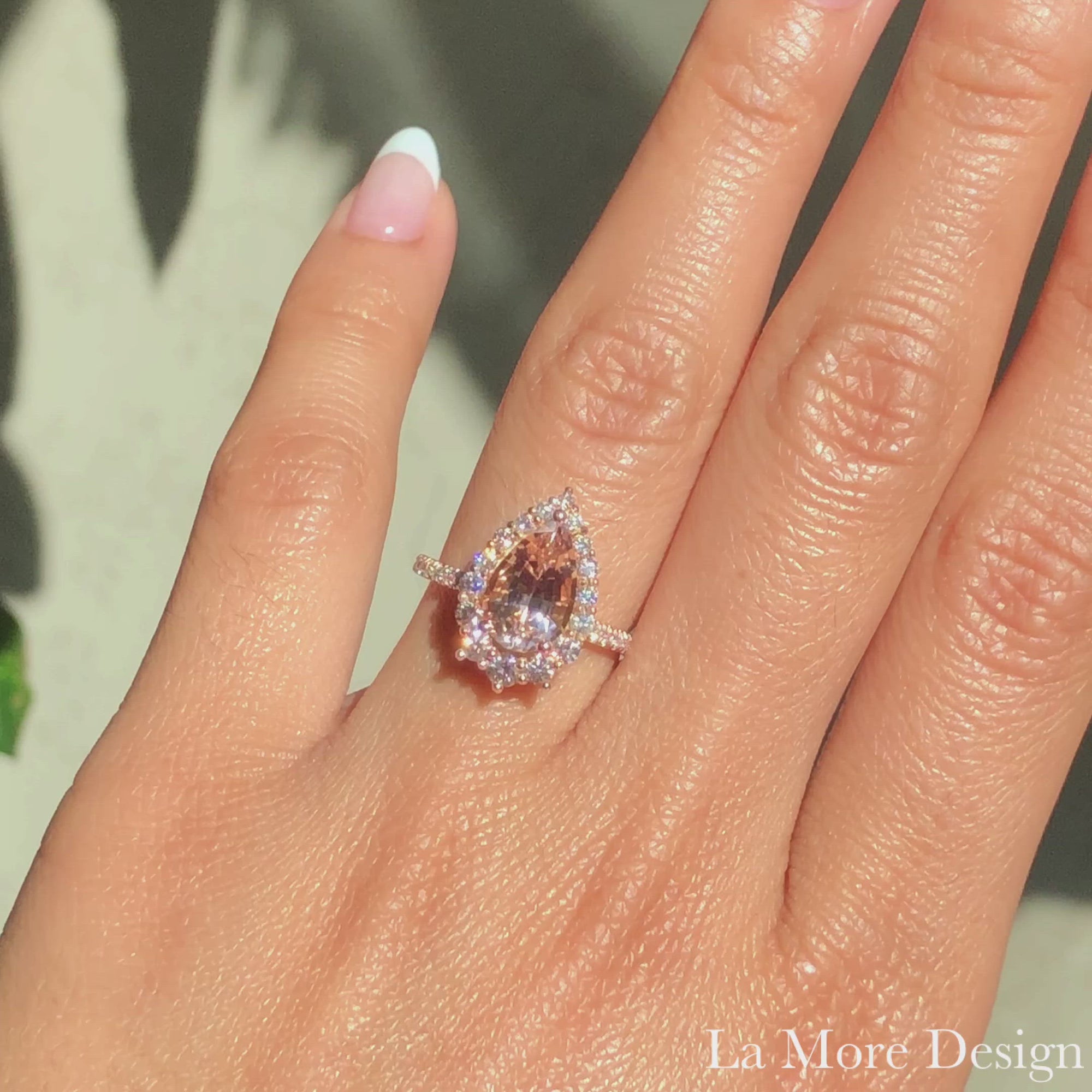 Breathtakingly unique and stunning! This morganite engagement ring is crafted in 14k rose gold Tiara Halo Diamond ring setting with a large 2.21-carat pear cut natural peach morganite center ~ total gemstone and diamond weight of the whole ring is 2.91 ct.tw.  This one-of-a-kind pear-cut engagement ring is perfect for brides looking for diamond alternative engagement rings! All our wedding bands can pair beautifully with this gorgeous halo diamond morganite ring!
