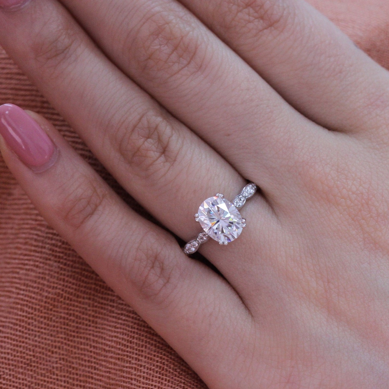 oval moissanite solitaire engagement ring in white gold scalloped diamond band by la more design