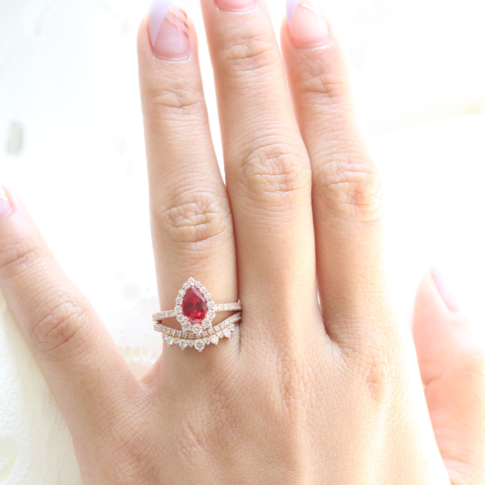 halo diamond ruby engagement ring bridal set rose gold and curved crown diamond wedding band by la more design jewelry