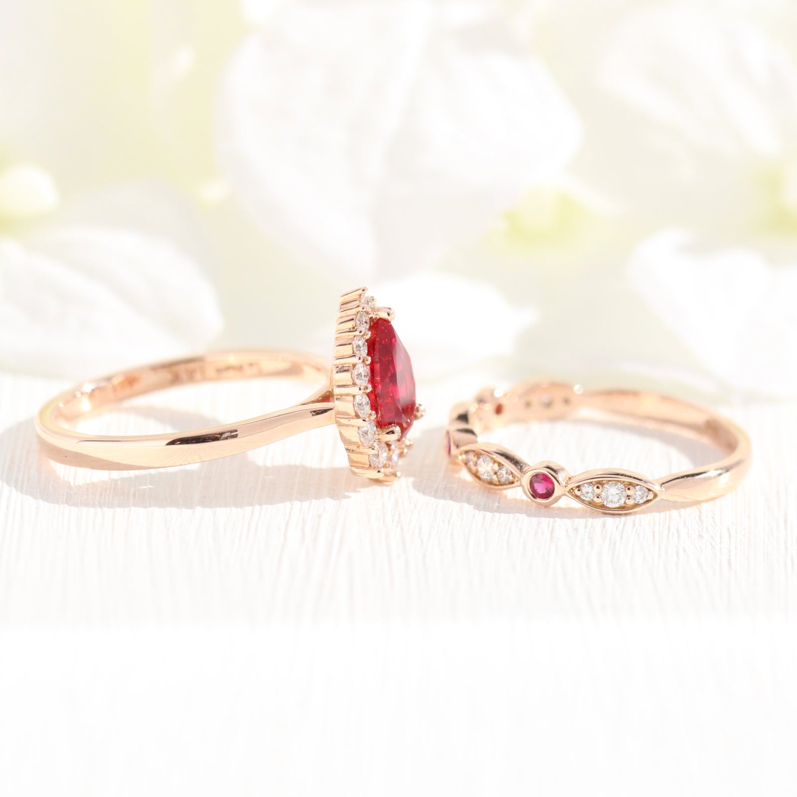 halo diamond ruby engagement ring rose gold pear shaped ring and diamond wedding band by la more design jewelry