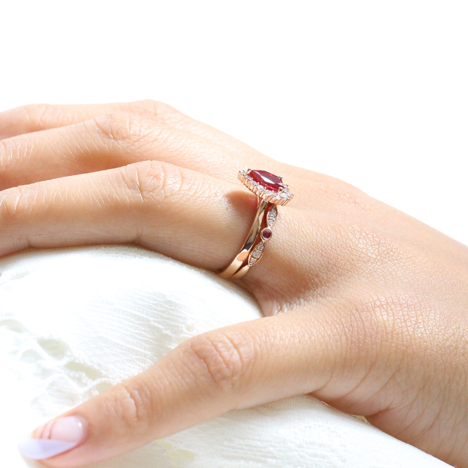 halo diamond ruby engagement ring rose gold pear shaped ring and diamond wedding band by la more design jewelry