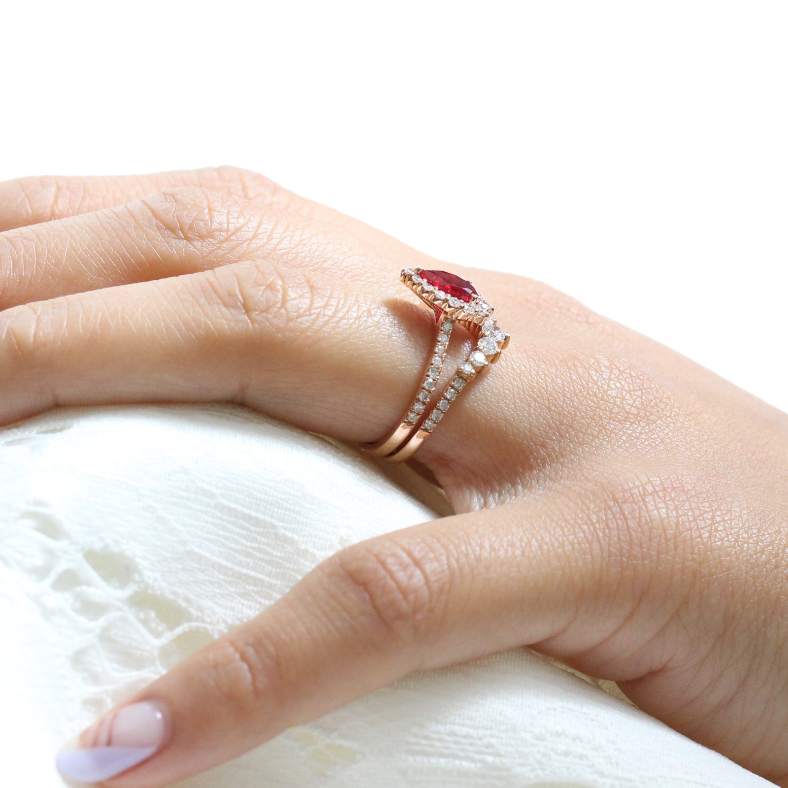 halo diamond ruby engagement ring rose gold pear shaped ring and pave diamond wedding band by la more design jewelry