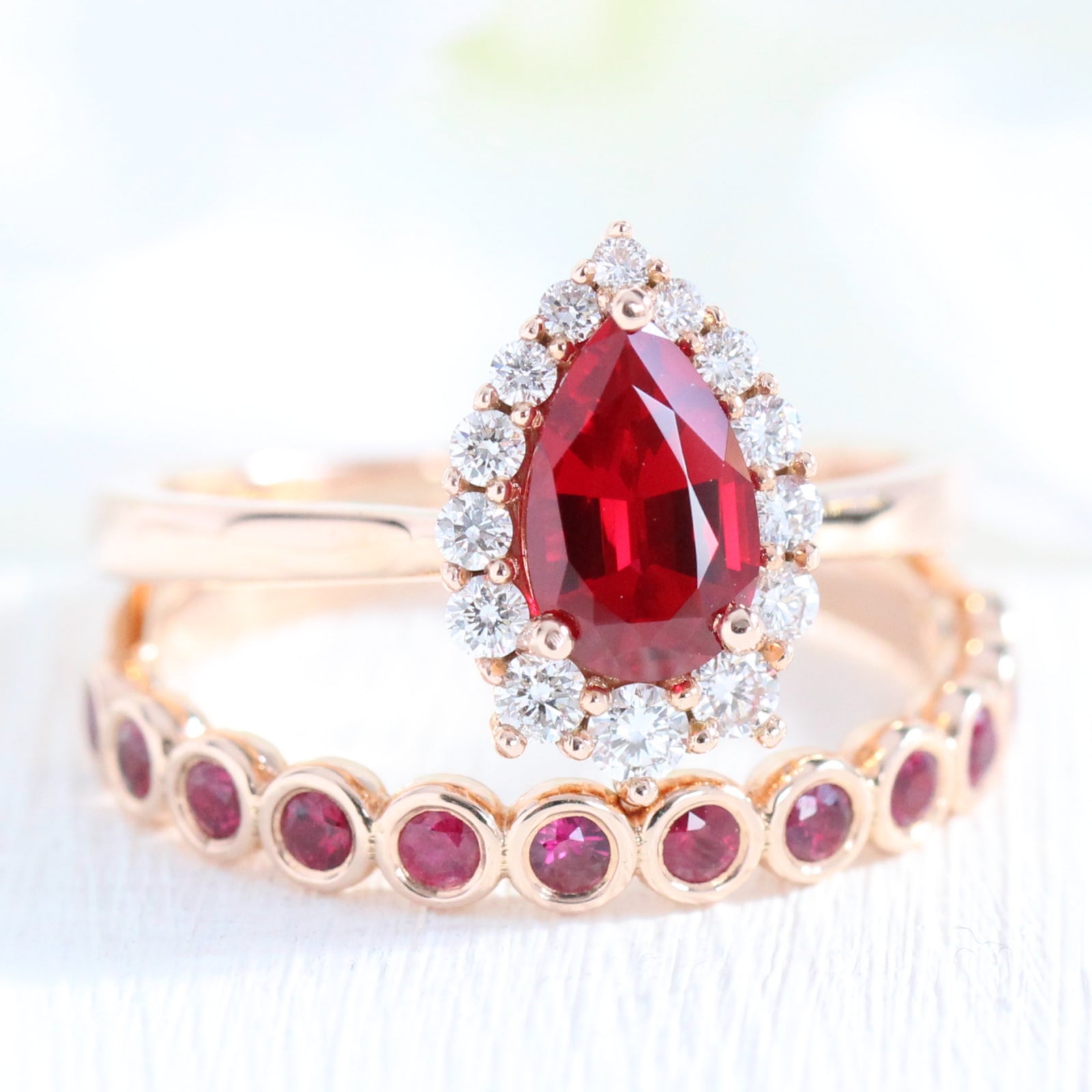 halo diamond ruby engagement ring bridal set rose gold and bezel ruby wedding band by la more design jewelry