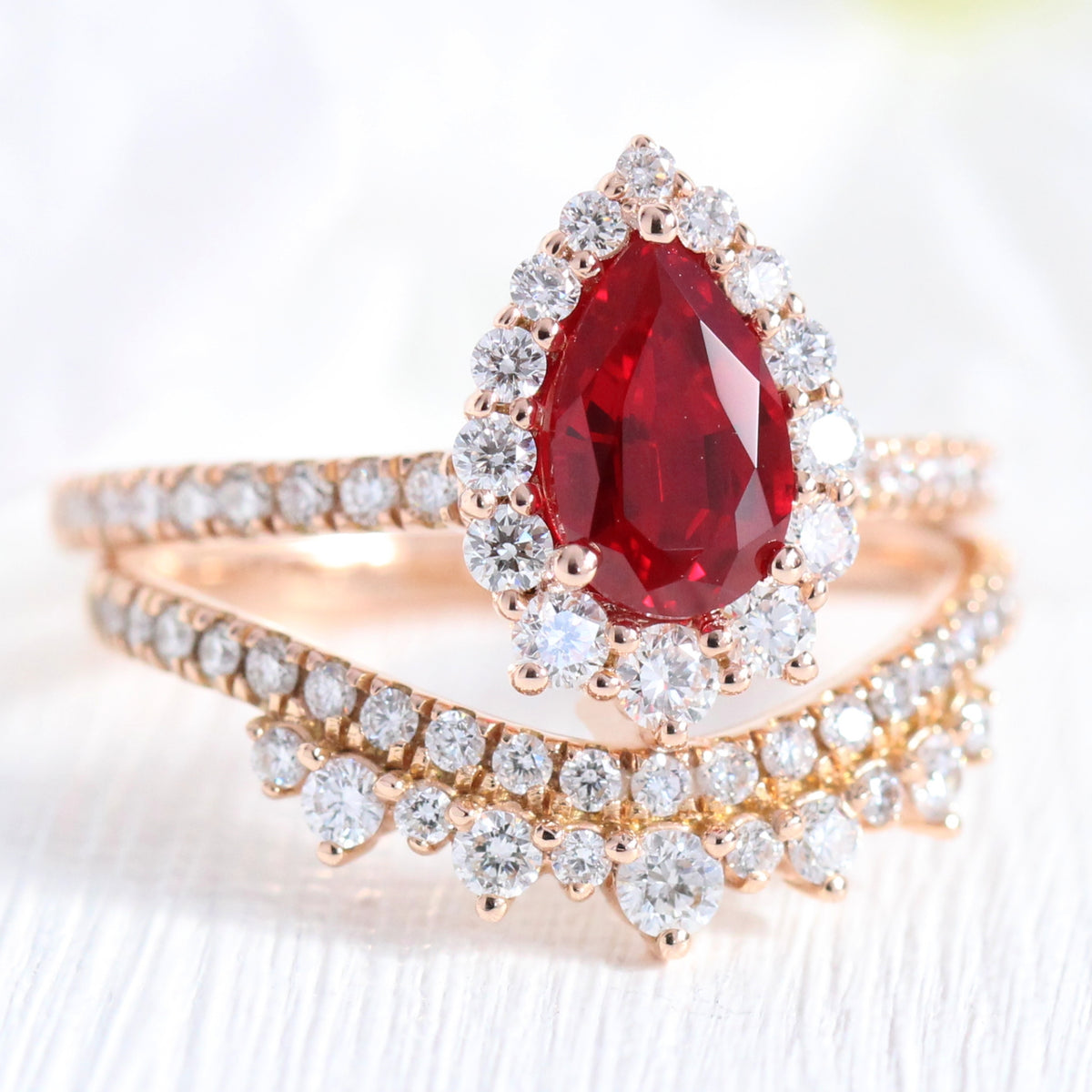halo diamond ruby engagement ring bridal set rose gold and curved crown diamond wedding band by la more design jewelry